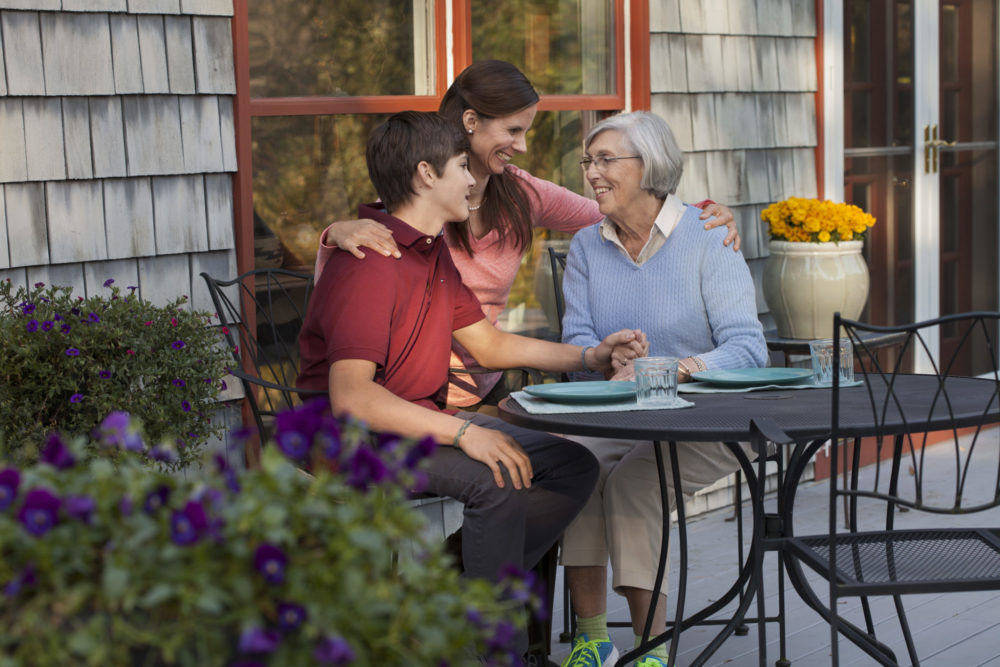 Grandma enjoying a meal with her daughter and grandson.