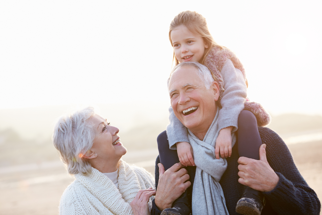 HopeHealth Provides Compassionate Care in Rhode Island and Massachusetts Grandparents And Granddaughter Walking On Winter Beach Laughing
