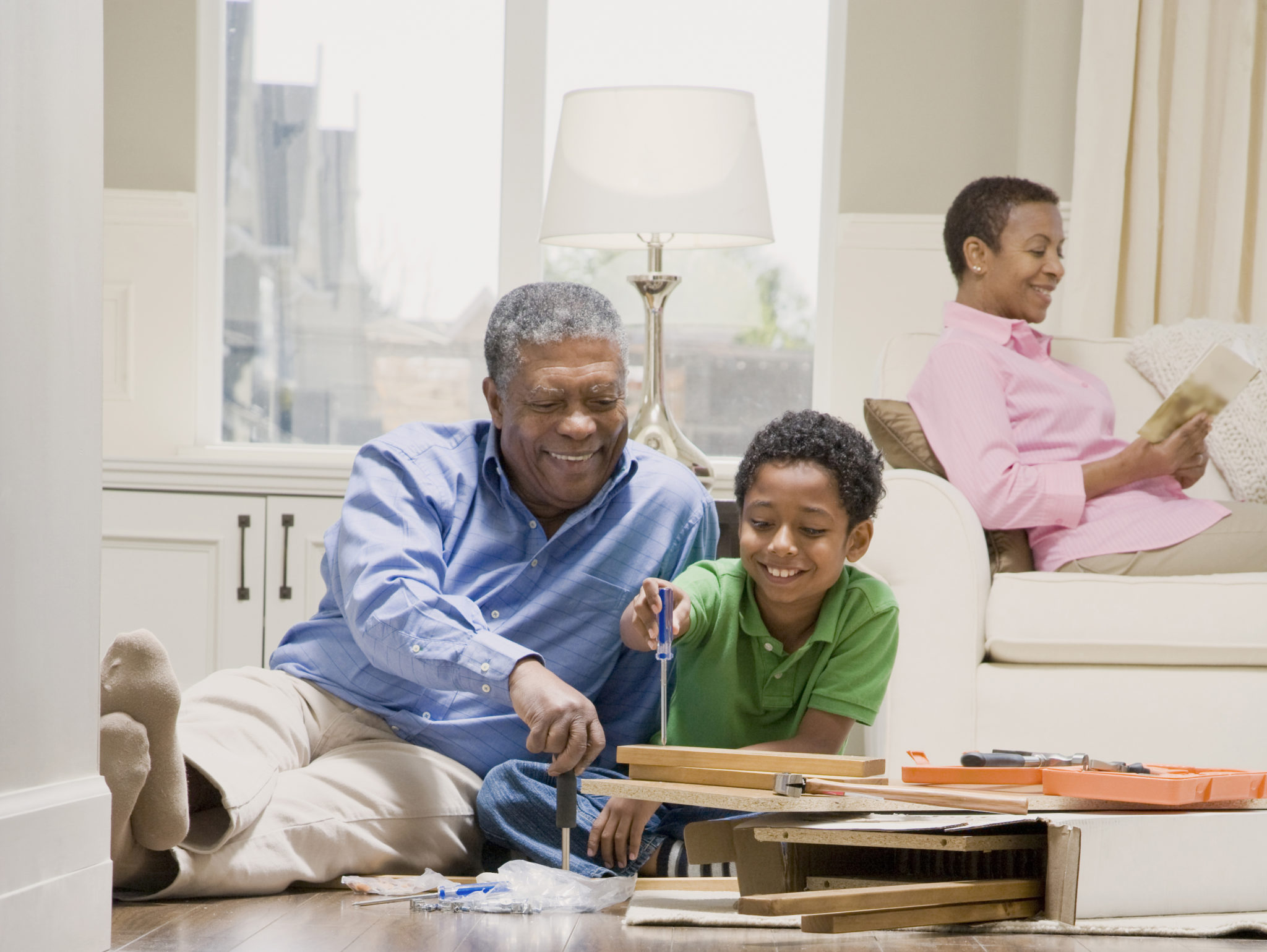 Grandfather Assembling Furniture With Grandson