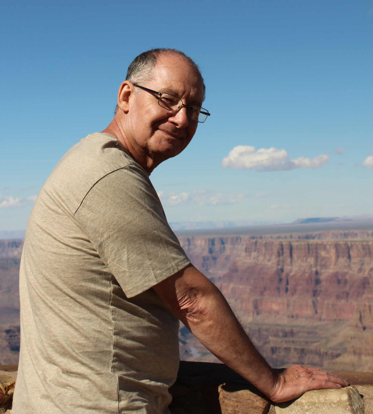 man staring back from a view of the Grand Canyon