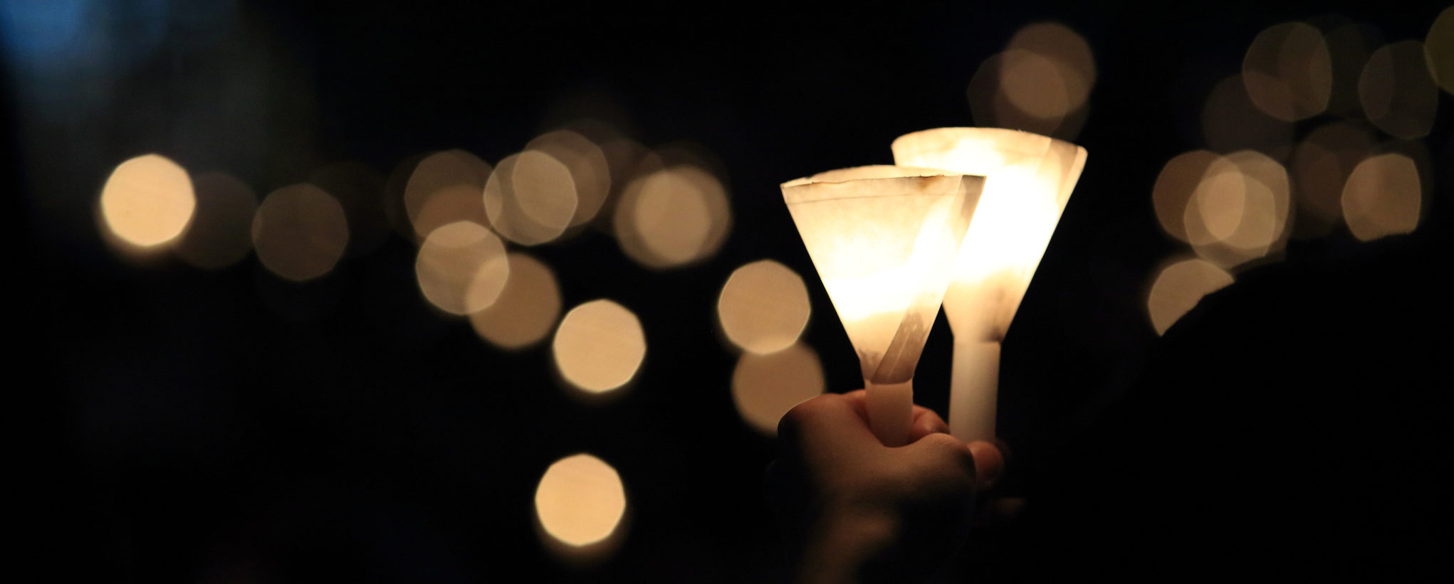 finding the light in dark. a haza candlelight vigil find each other in darkness, blur background in hong kong victoria park