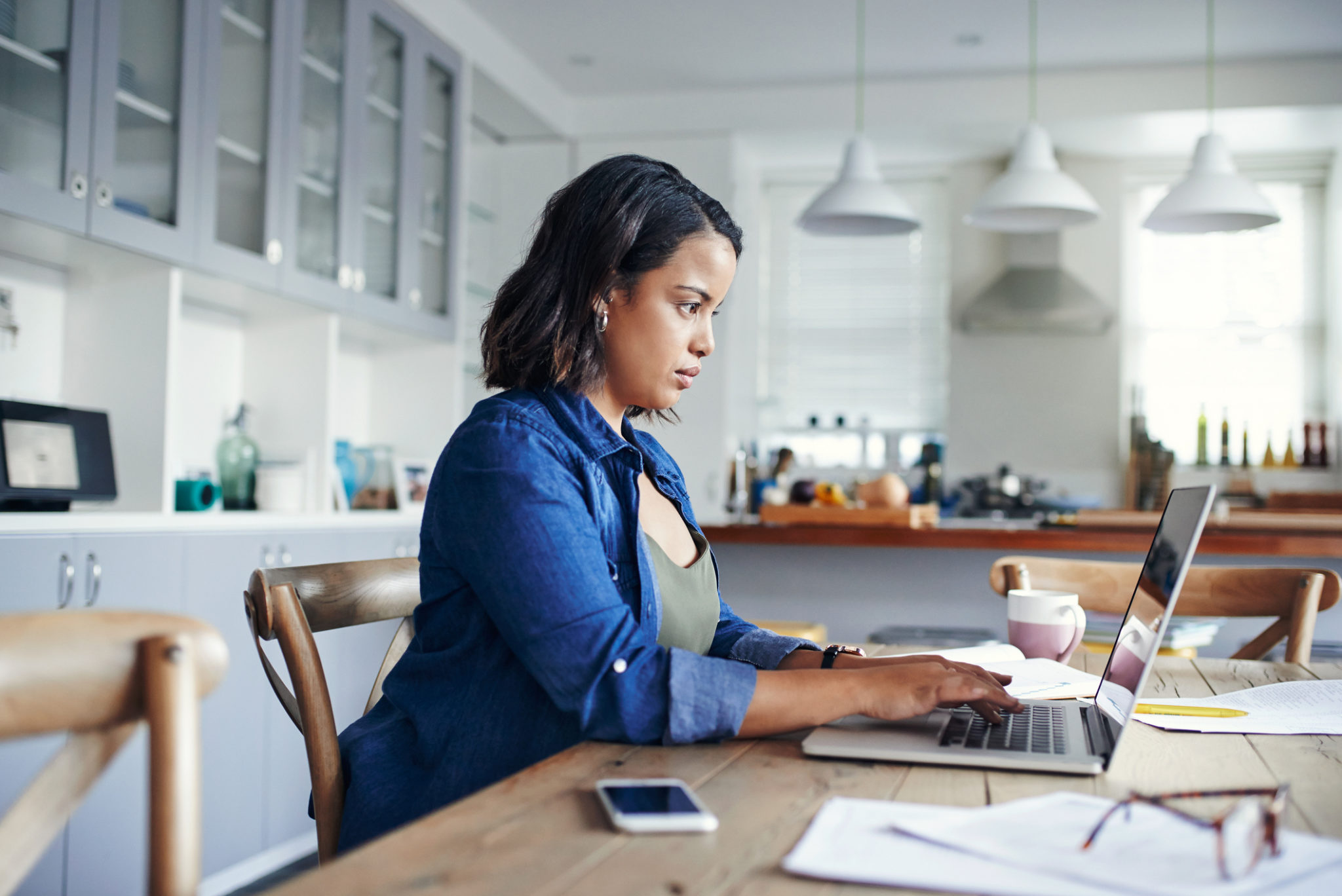 Shot of a young woman using a laptop while working from home