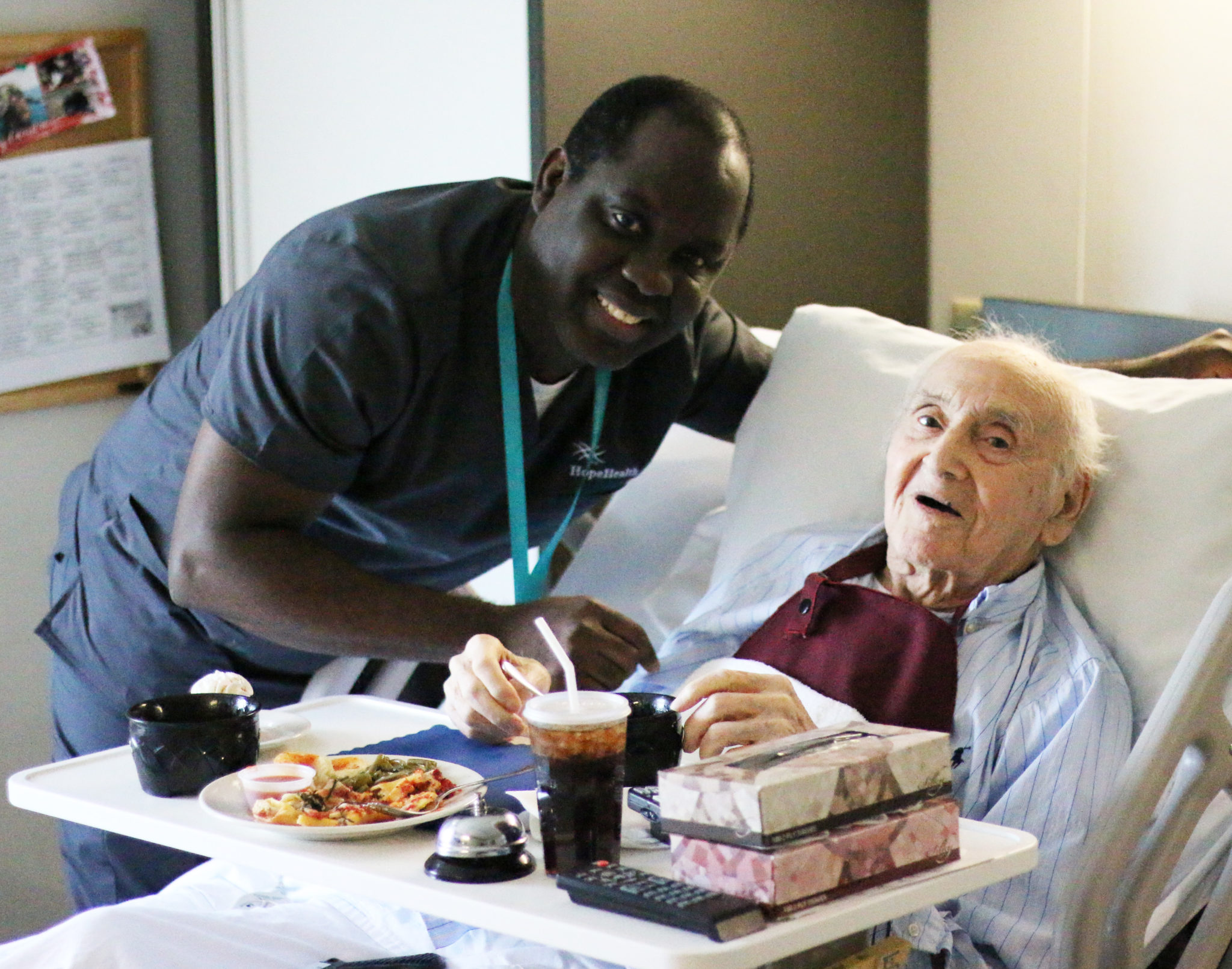 Young man standing with geriatric patient