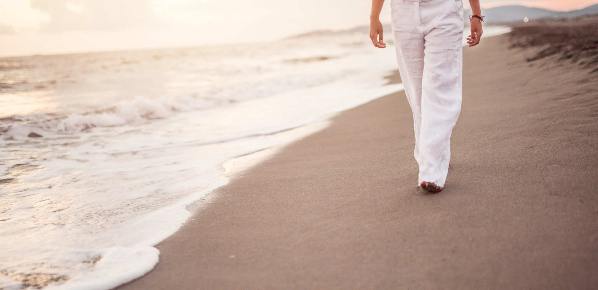 Unrecognizable young woman walking on beach concept.