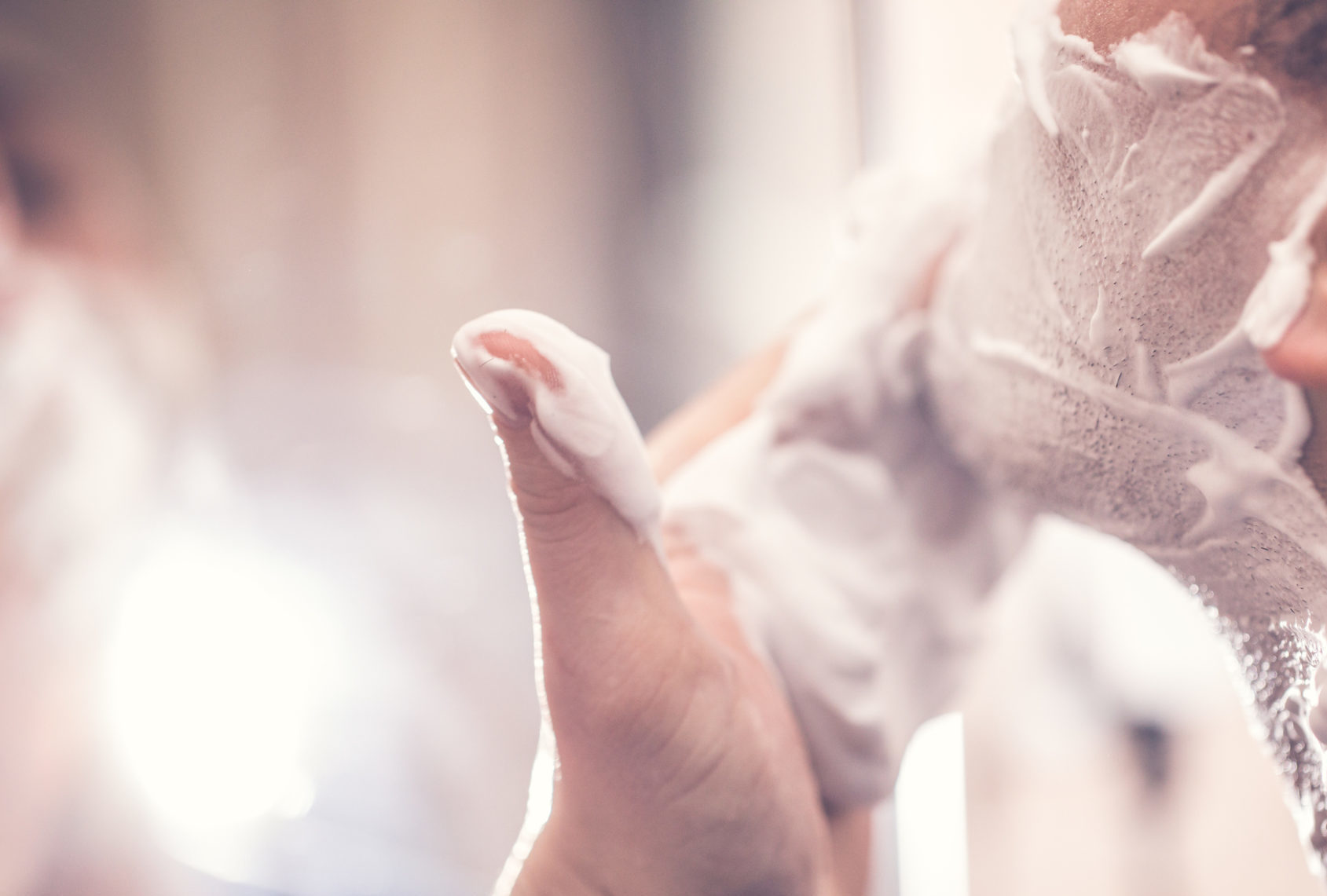 One man in the bathroom , Shaves his beard 