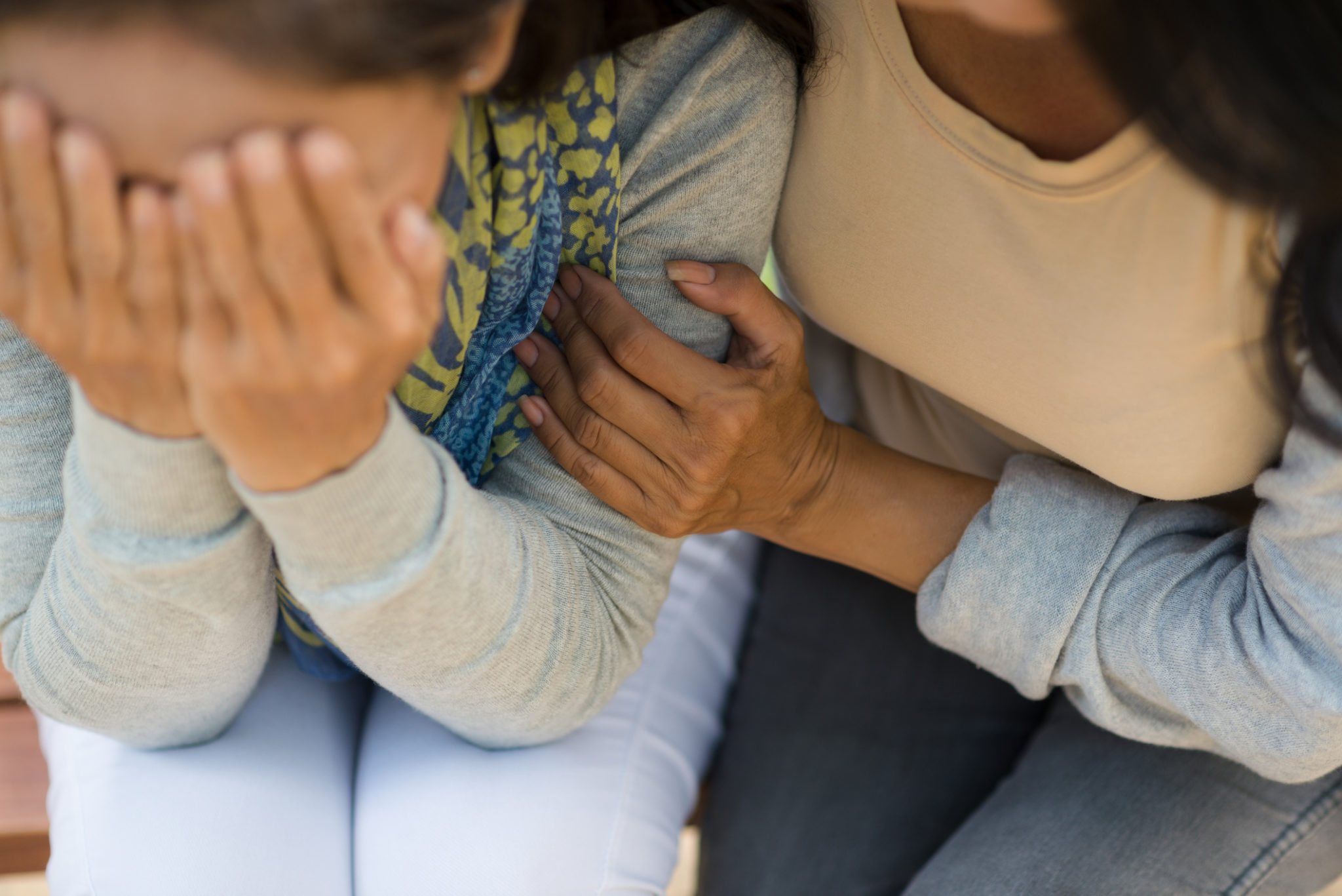 Woman comforting desperate hopeless friend, view from above