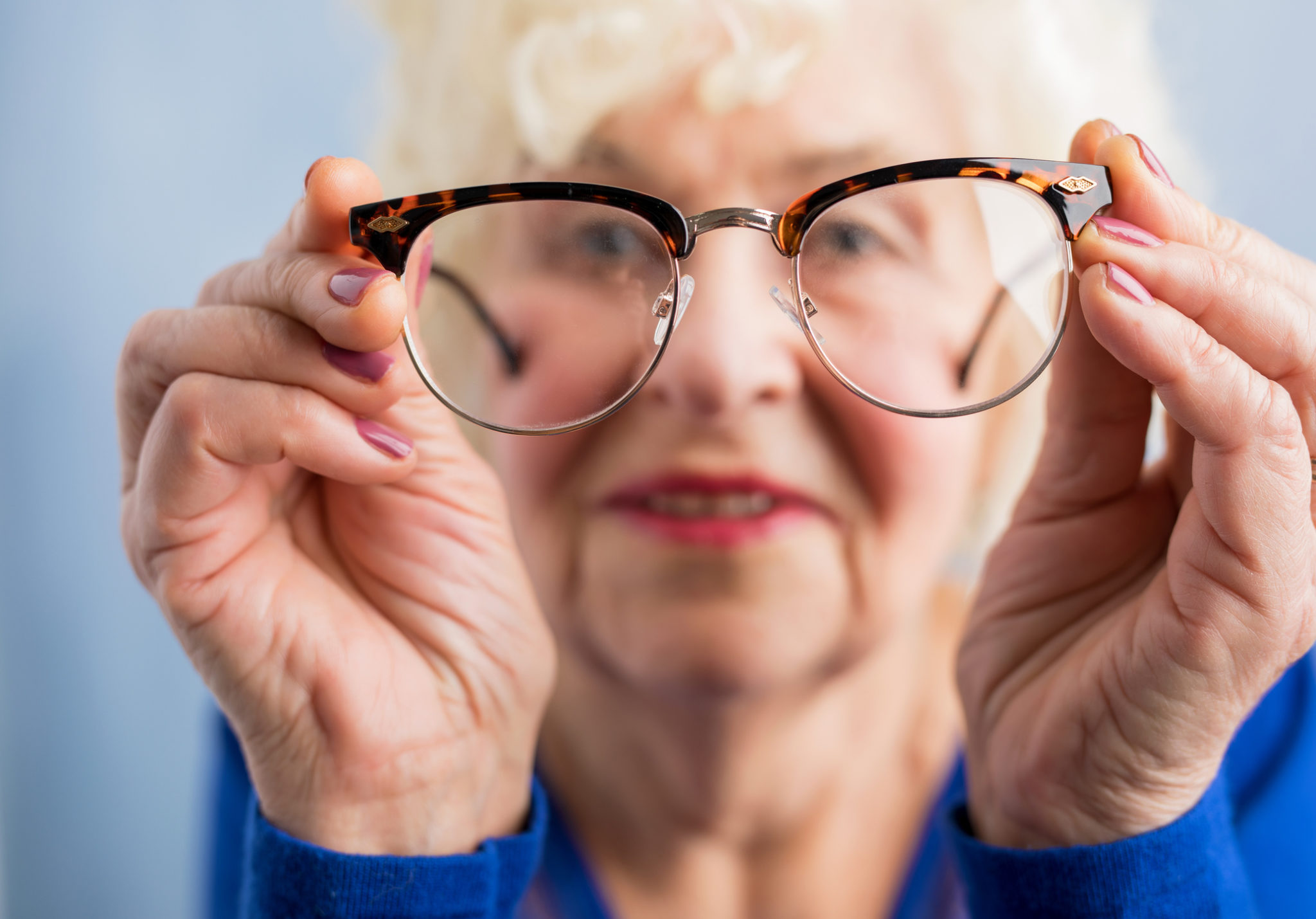 Grandma looking through her glasses to see better