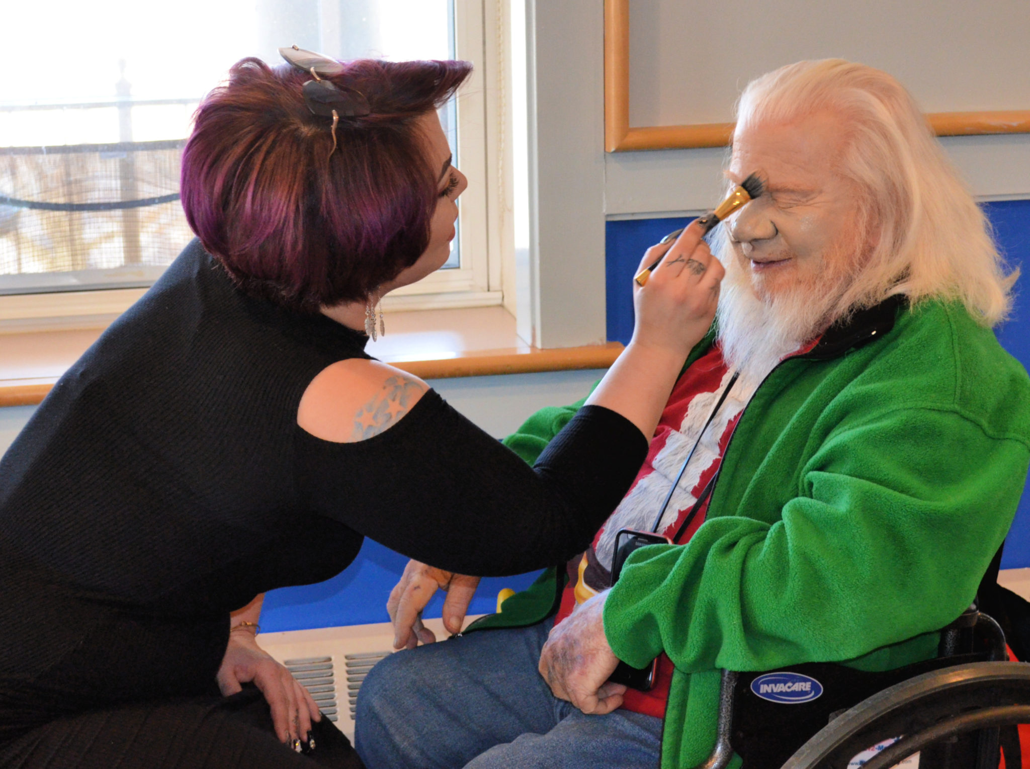 Elderly man getting his makeup done