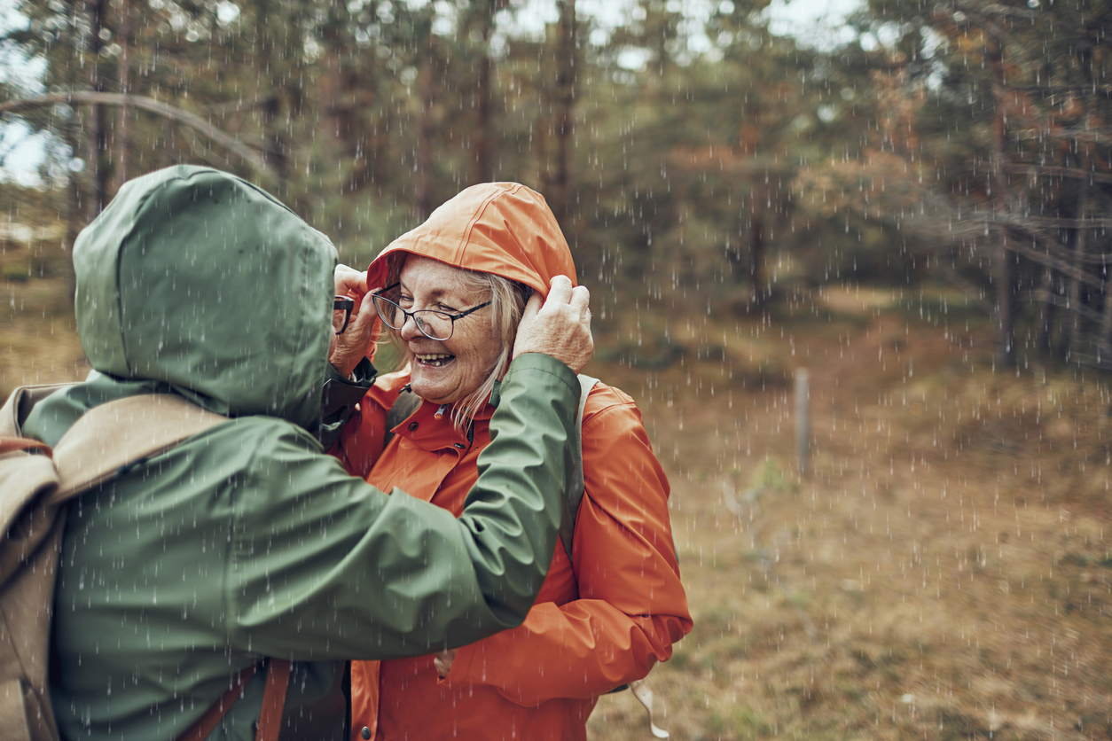 Close up of two female seniors hiking through the forest