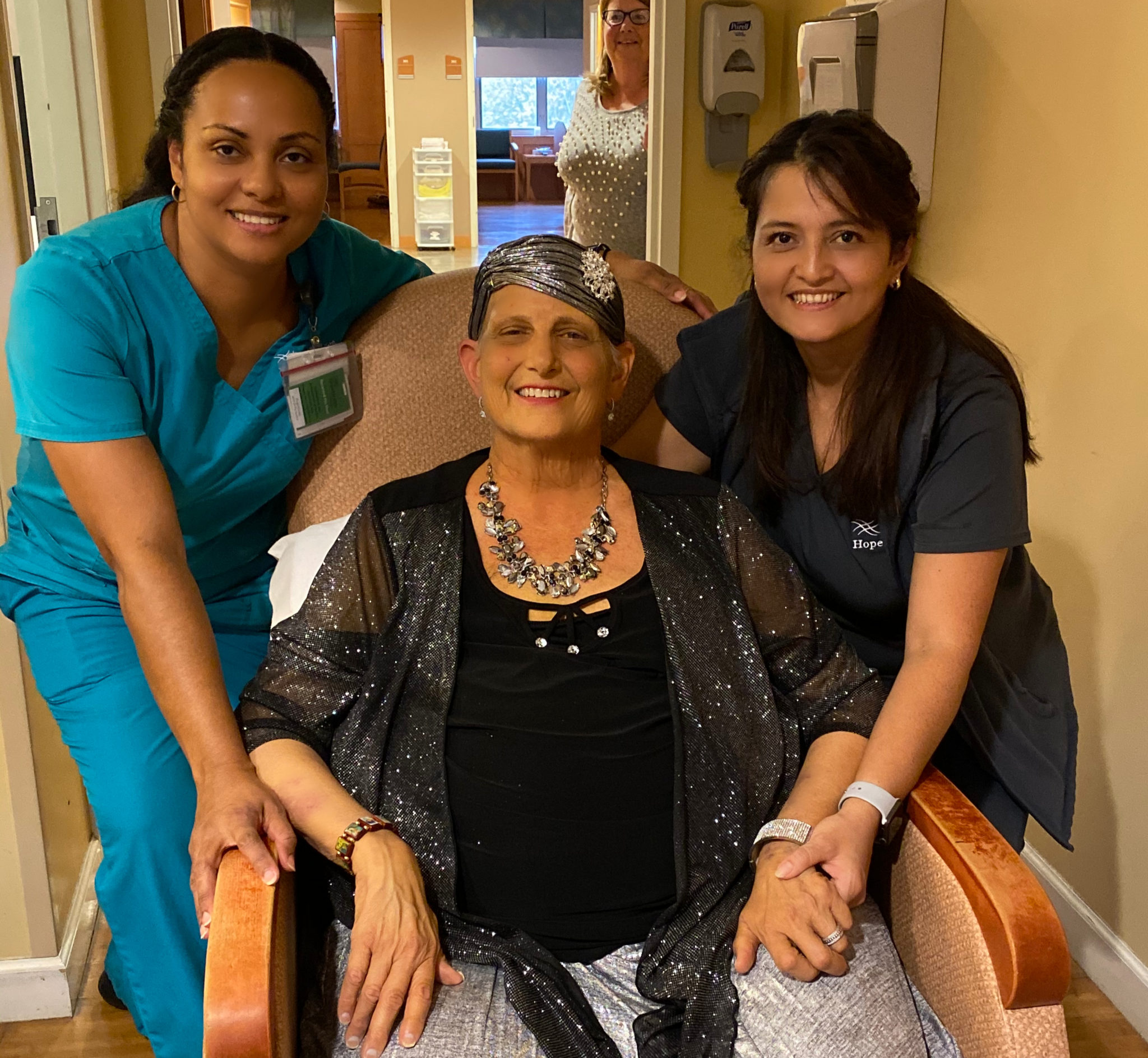 HopeHealth's hospice aides stand on either side of the patient after getting her ready for her sons wedding