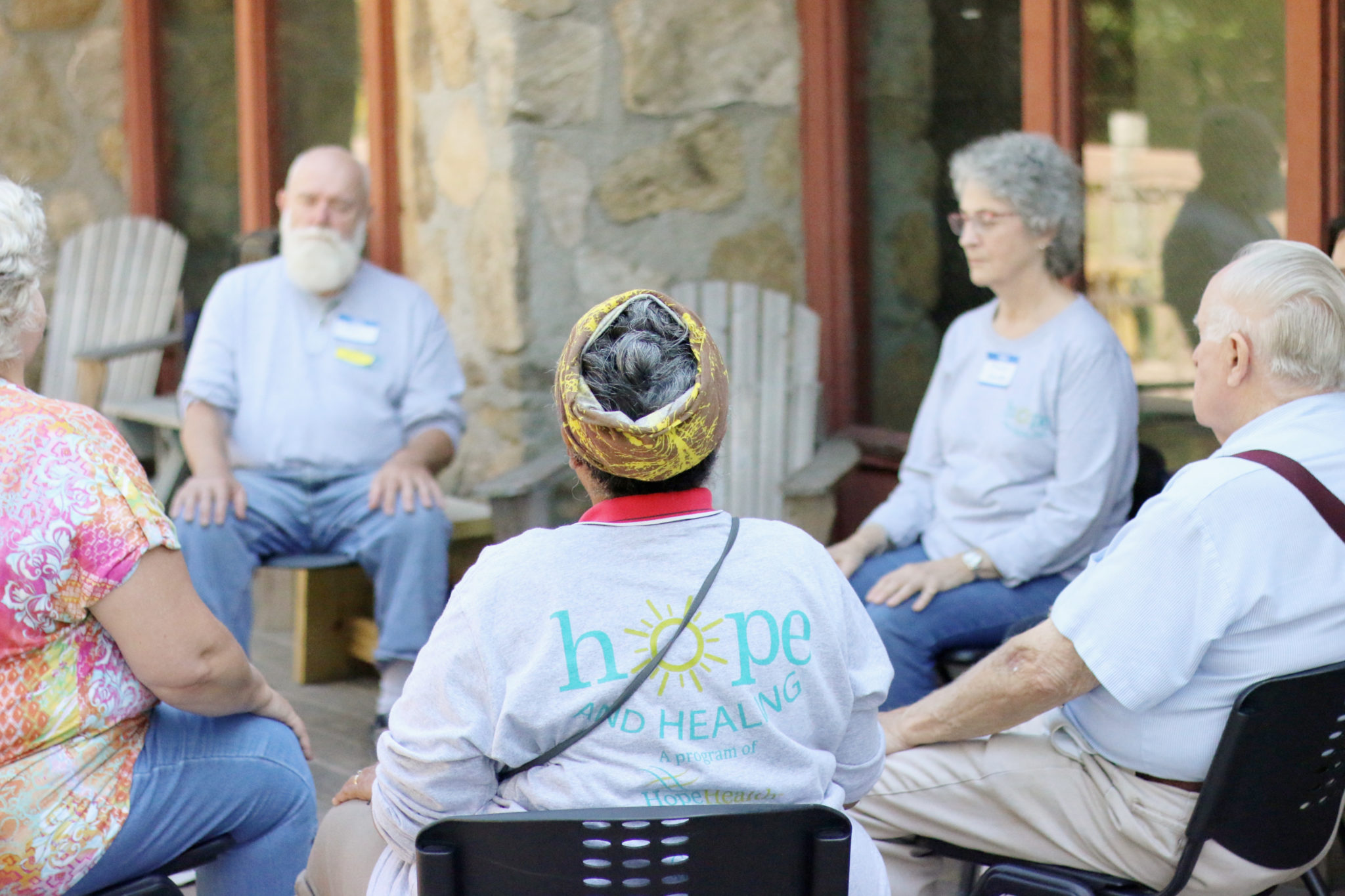 Group of men and women meditating for grief support