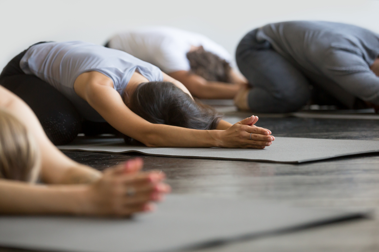 Group of people doing yoga as a form of grief support with HopeHealth