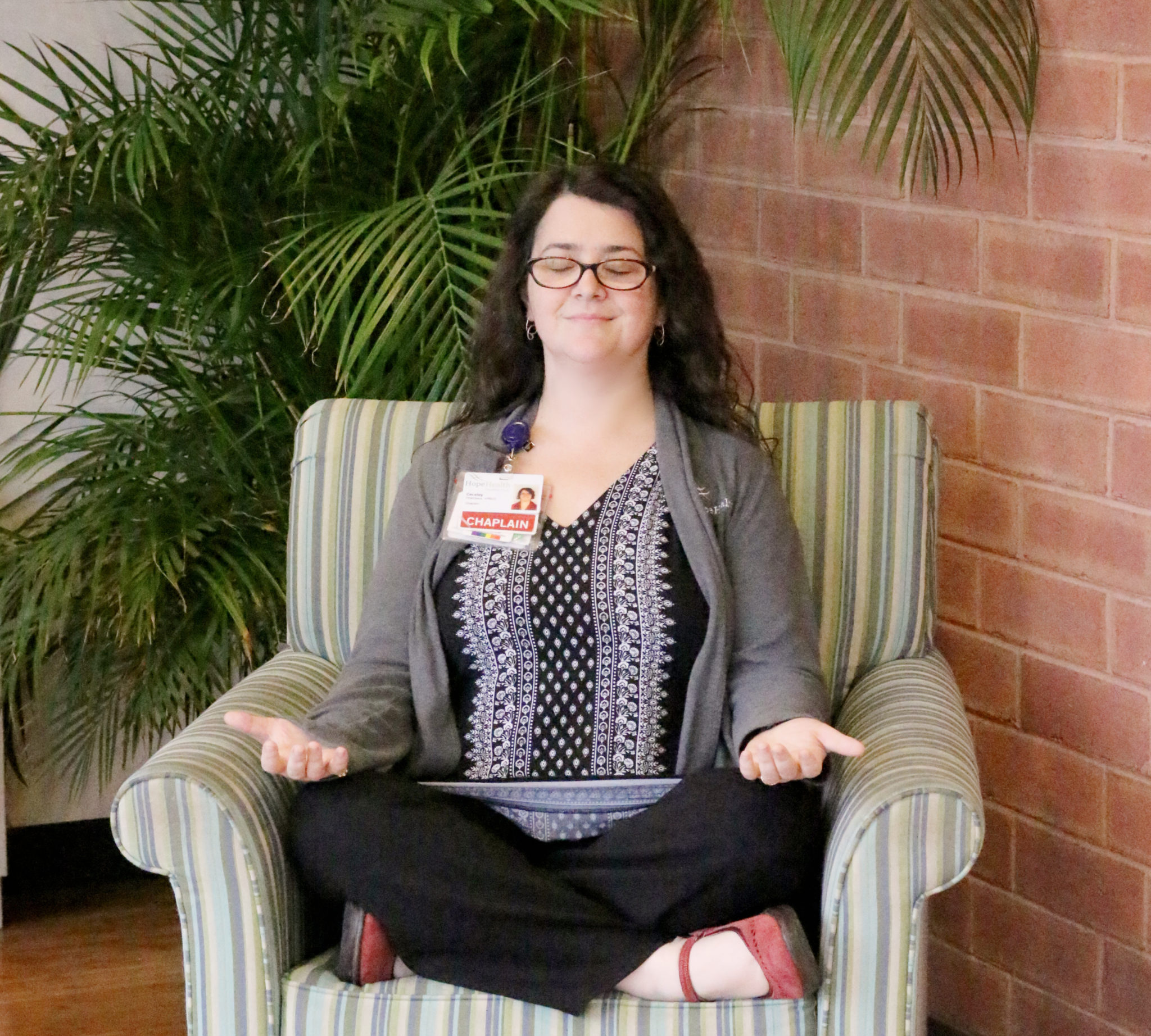 Woman meditating in chair is finding calm amidst coronavirus COVID-19