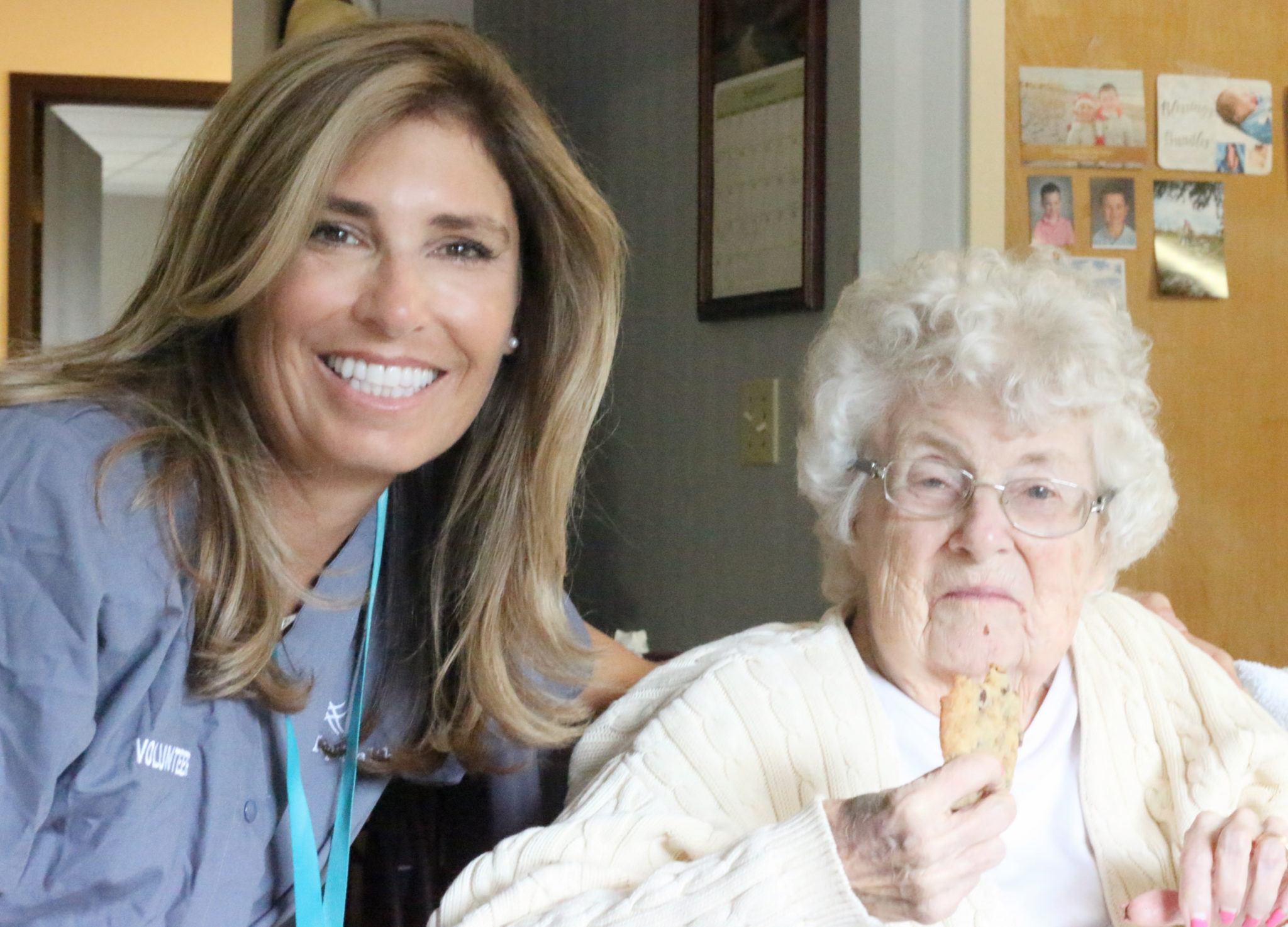 A female hospice volunteer poses with an elderly female patient