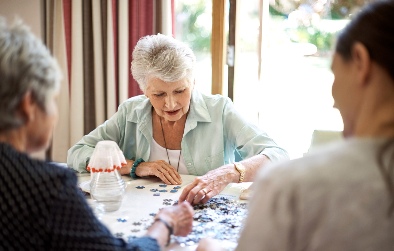 Shot of senior residents building a puzzle in a retirement home