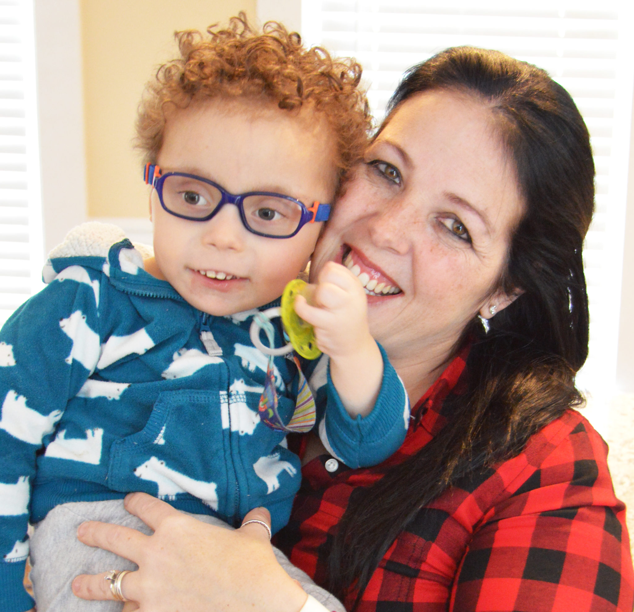 Juliana Oliveira holds her son Josue Oliveira. She is happy to see him doing well with pediatric palliative care