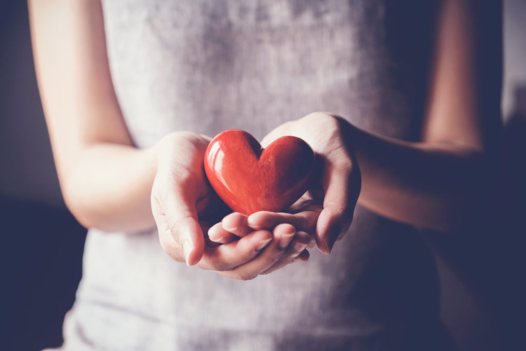 woman holding red heart, health insurance, donation charity concept