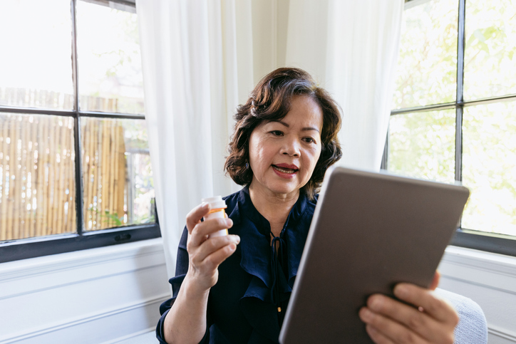 Senior woman talks with a doctor online Senior woman discusses her prescription medication at home on her tablet with remote patient monitoring