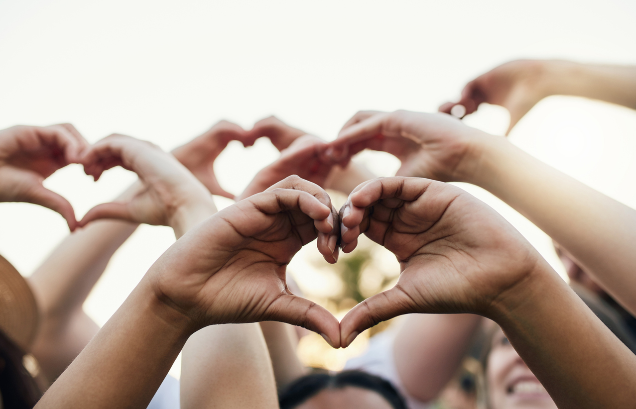 Love more, hate less Picture of hands forming a heart, representing connecting together virtually for a virtual hospice fundraising event