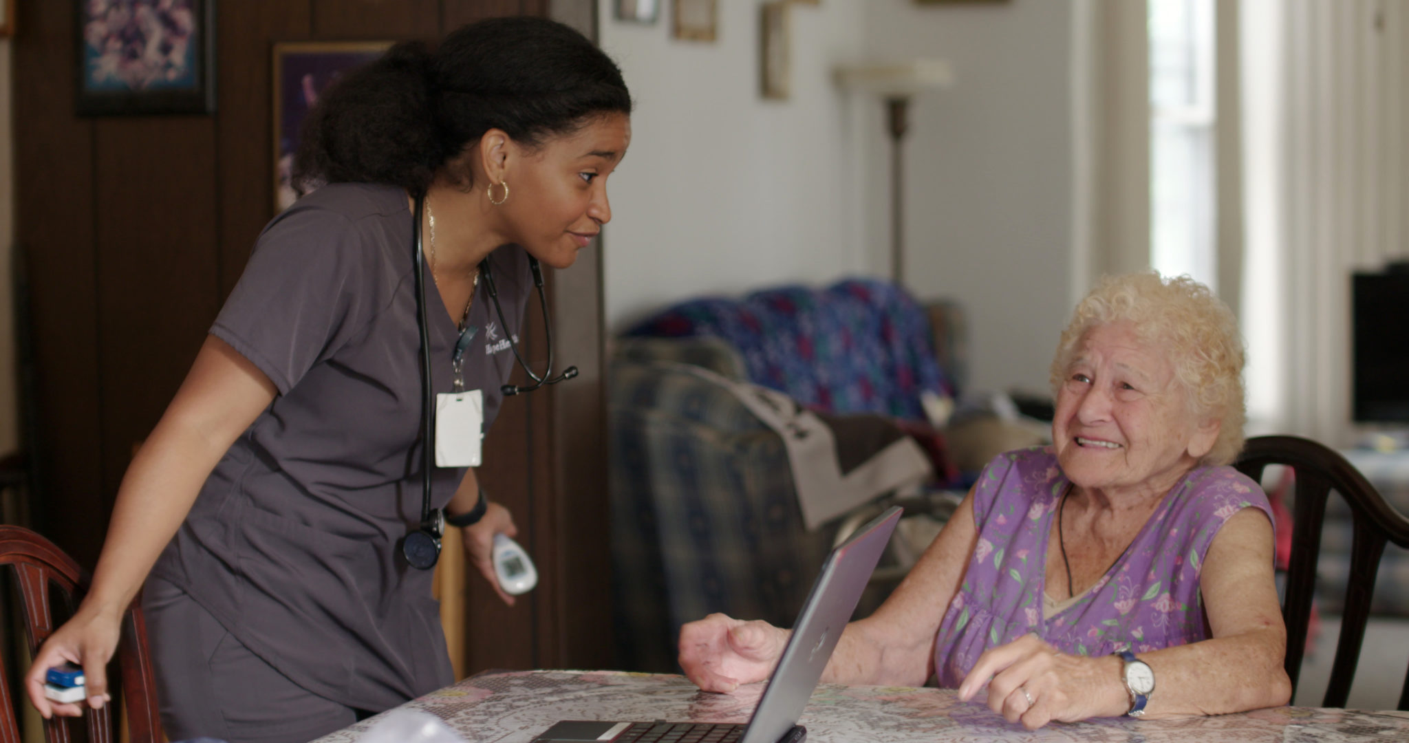Home care nurse chatting with patient at the table