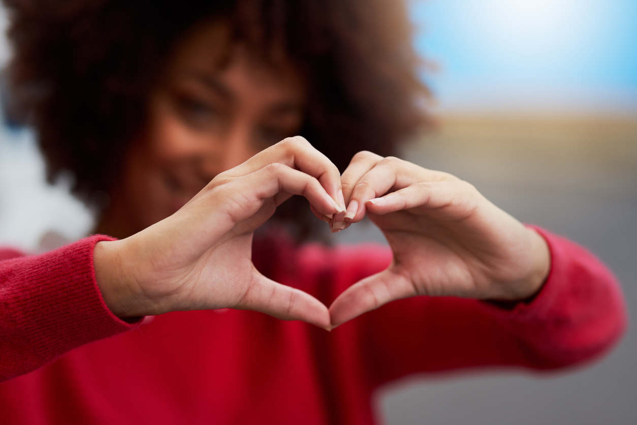 Love everything Cropped shot of an unrecognizable woman forming a heart shape with her fingers