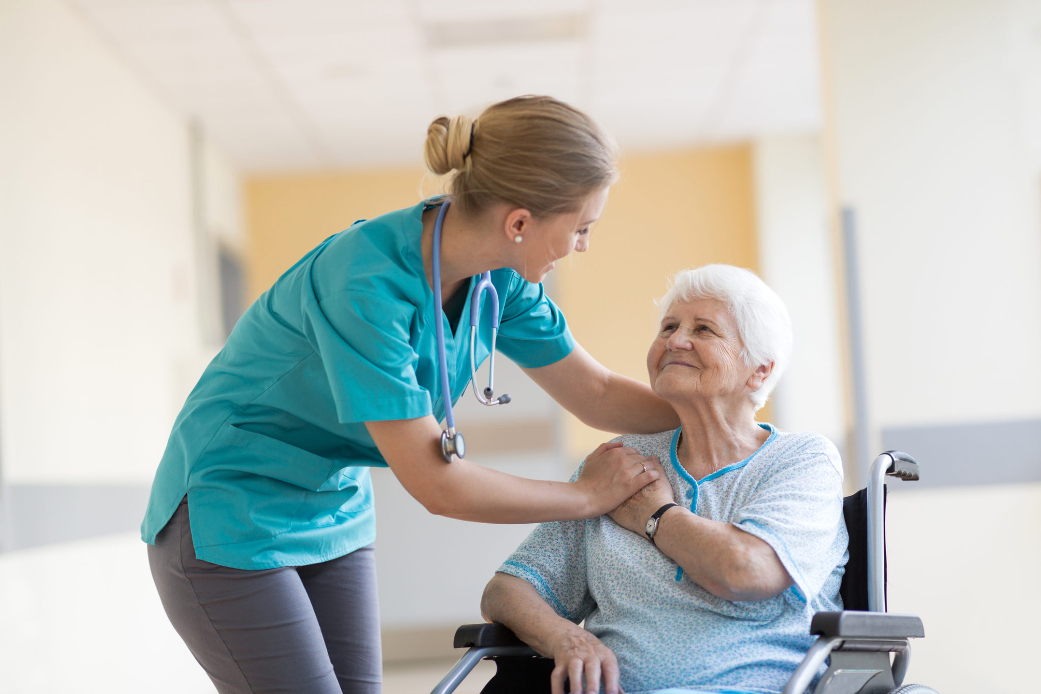 Senior woman in wheelchair with nurse in hospital Senior woman in wheelchair with nurse in hospital