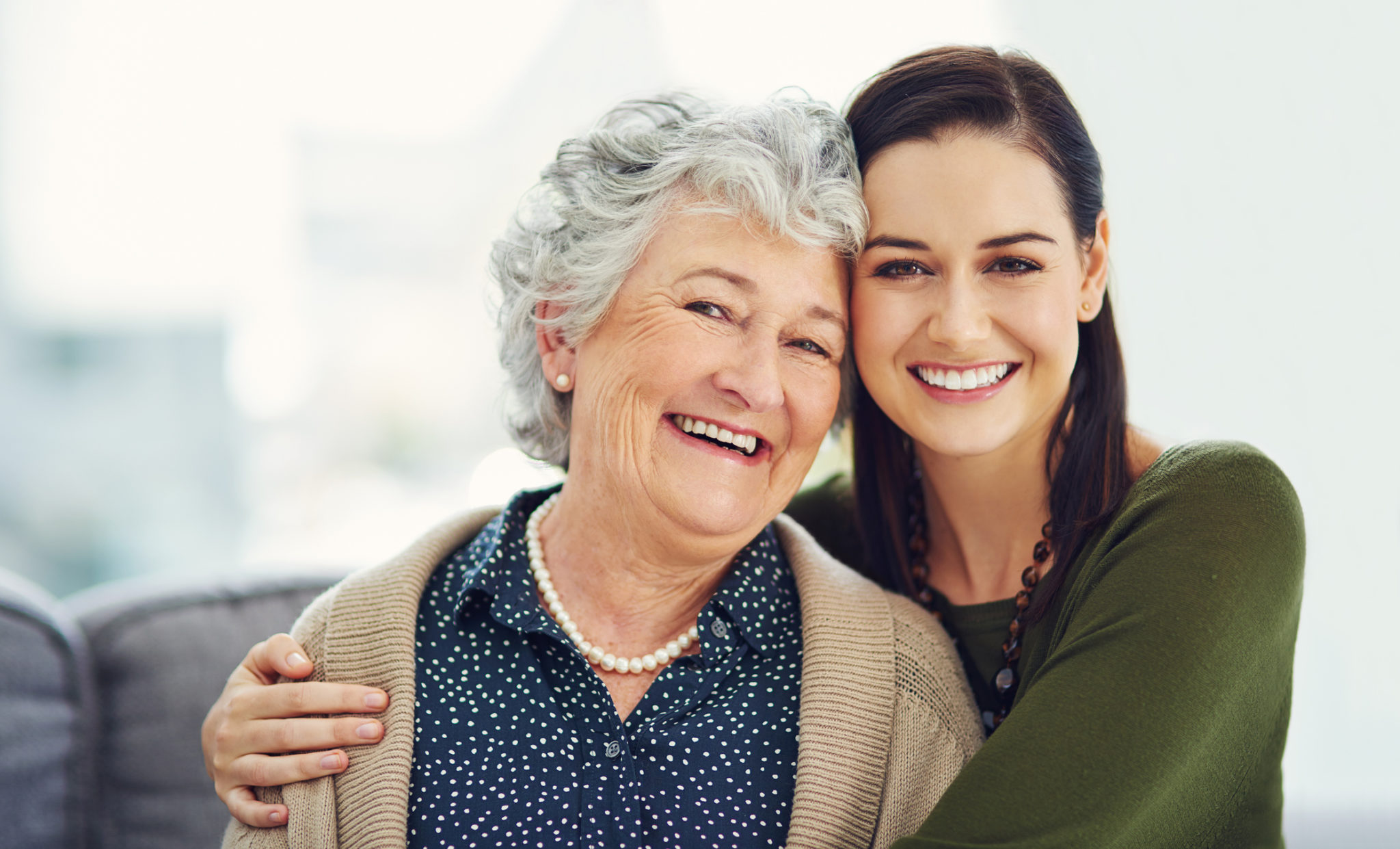 She taught me the value of love Portrait of a happy young woman spending time with her elderly relative at home