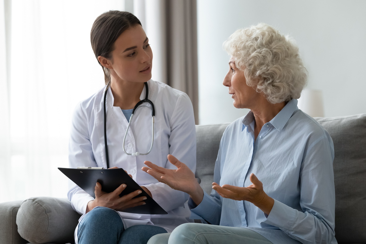 Female medical social worker discusses advanced directives with her female senior patient