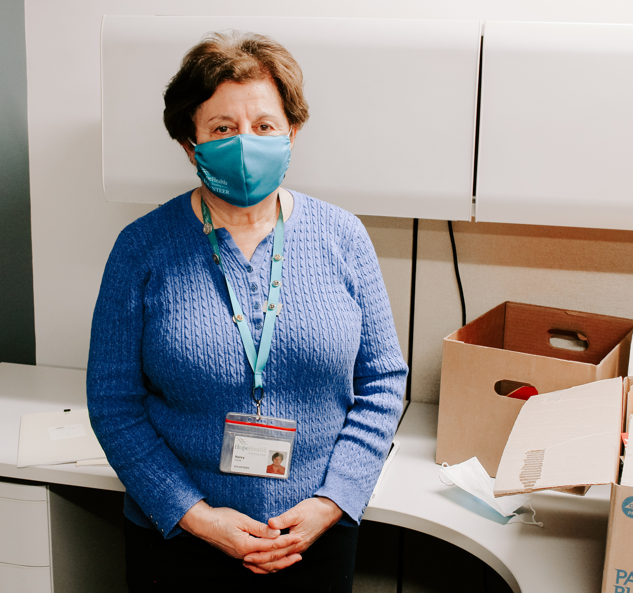 Female volunteer wearing a mask while returning to in-person volunteering in Rhode Island