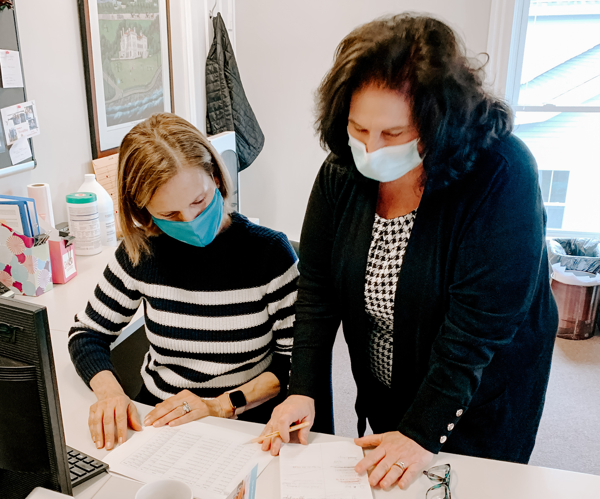 Volunteer Elayne Casey, left, with Administrative Assistant Ann Seaback in HopeHealth's Wakefield office.
