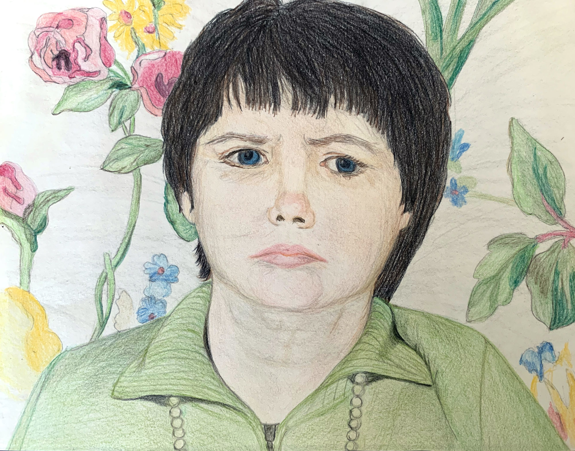 Colored pencil drawing of woman with dark hair and blue eyes wearing green shirt against floral chair