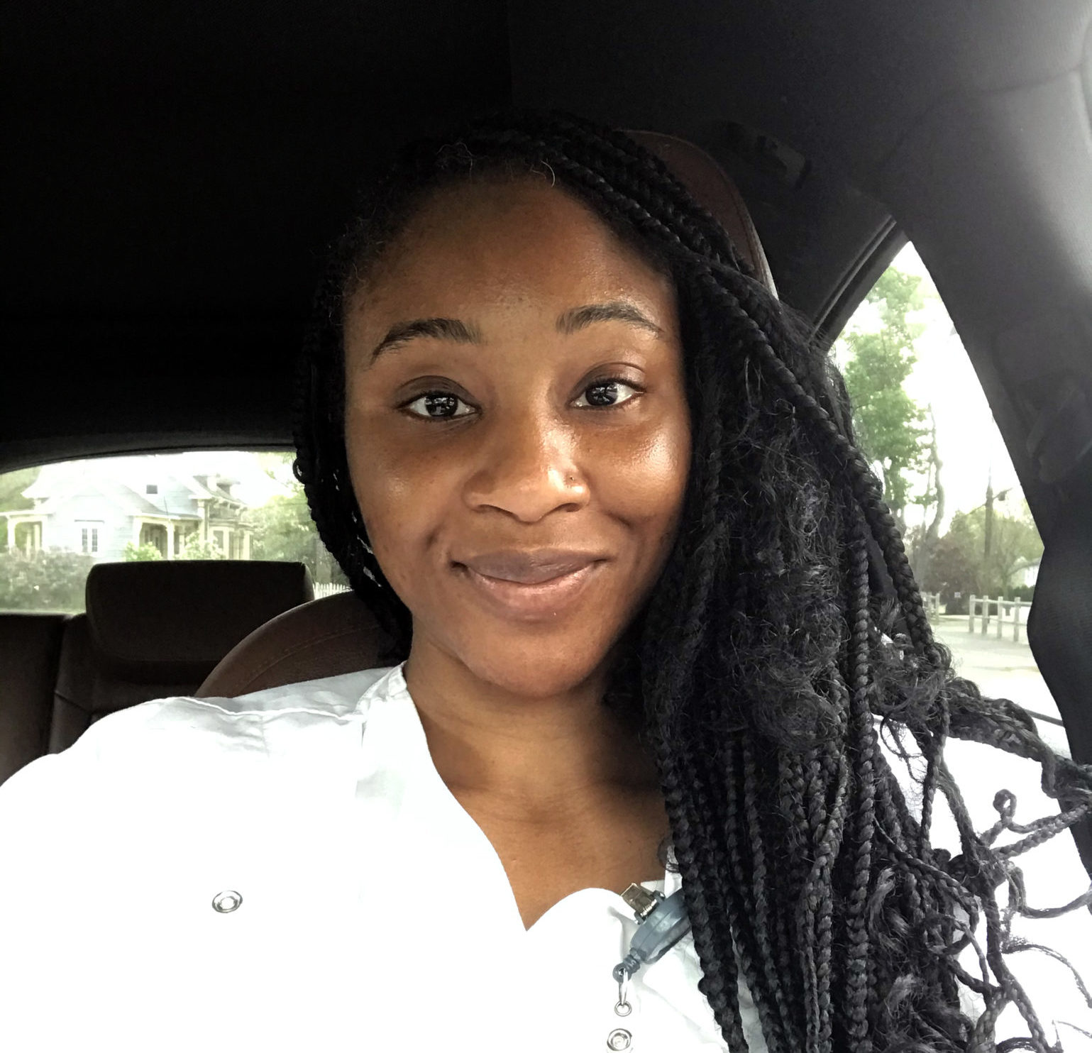 Nurse sitting in her car as she gets ready to drive to her patients home