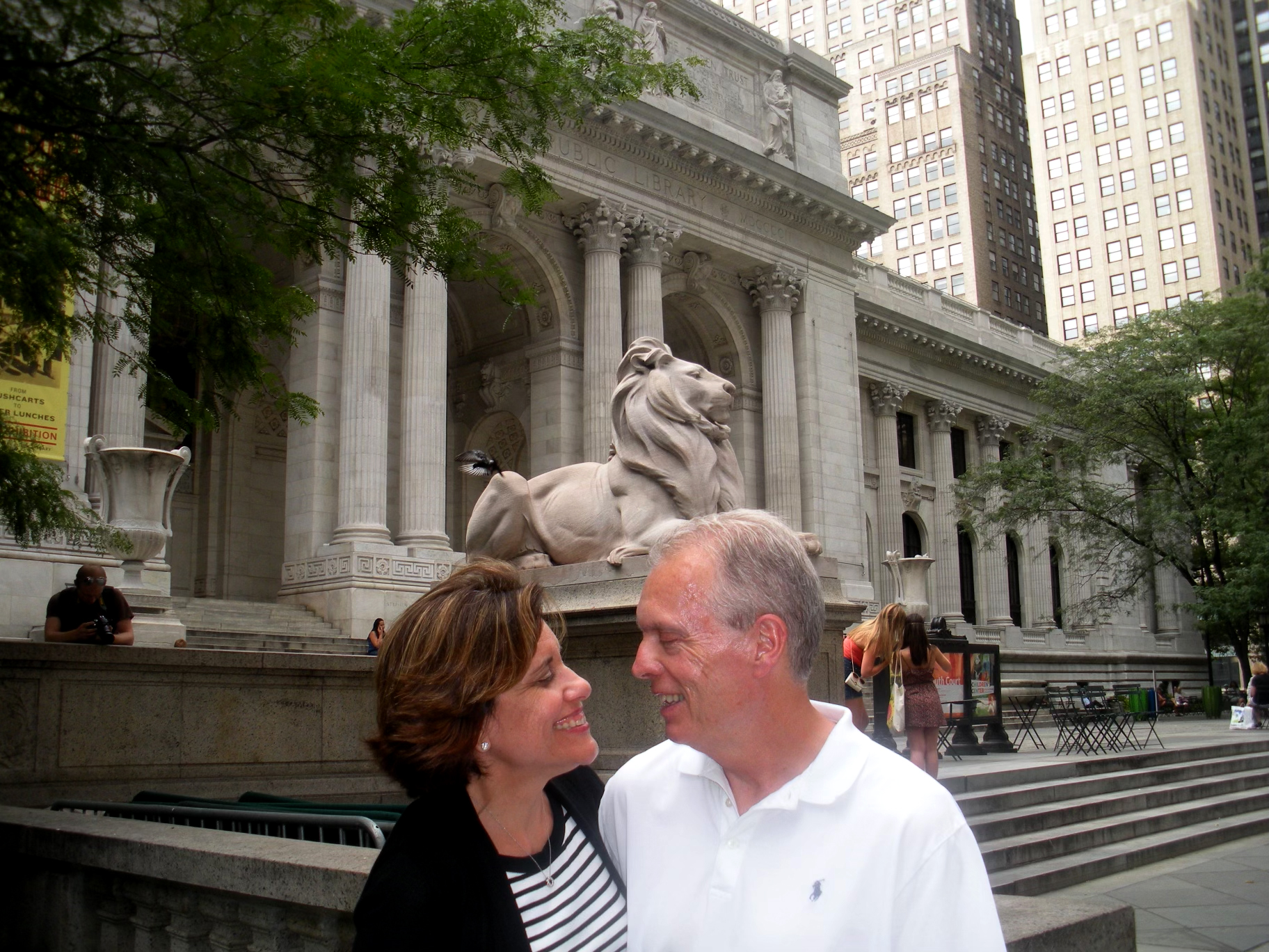 Woman and man look at each other in front of New York City Public Library