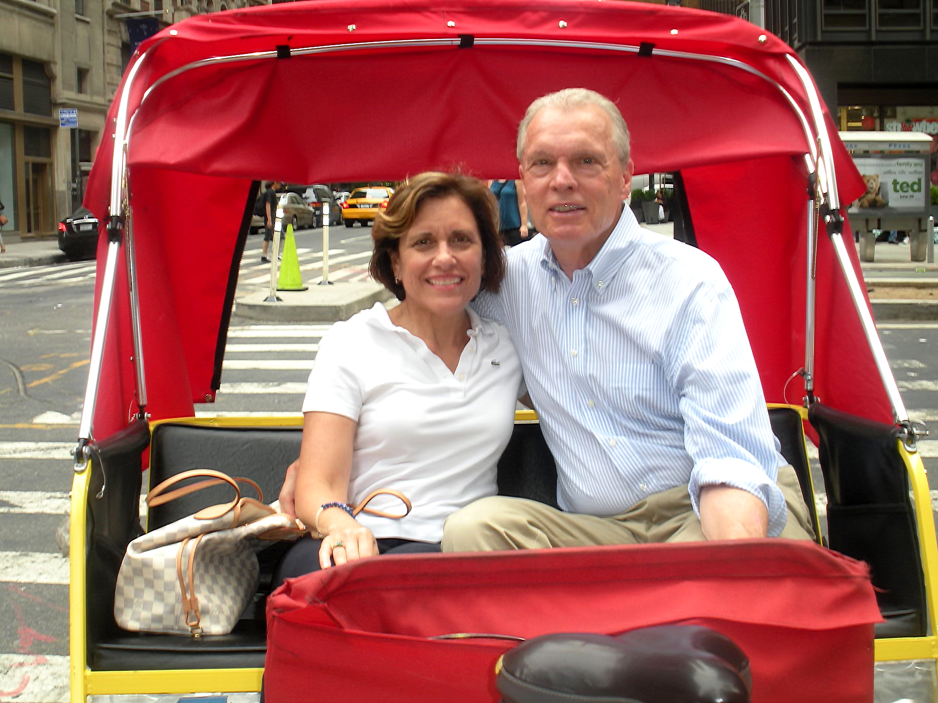 Woman and man in a red pedicab