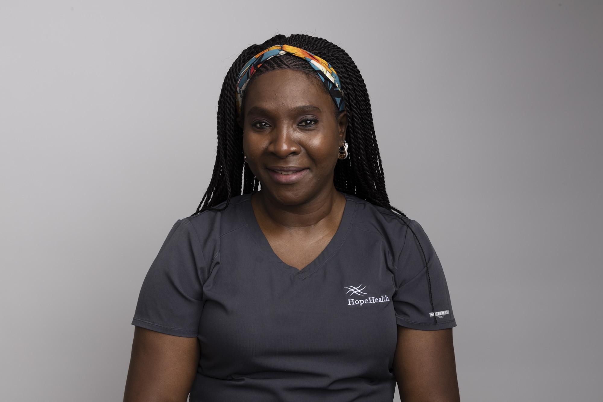 Hospice aide in gray scrubs