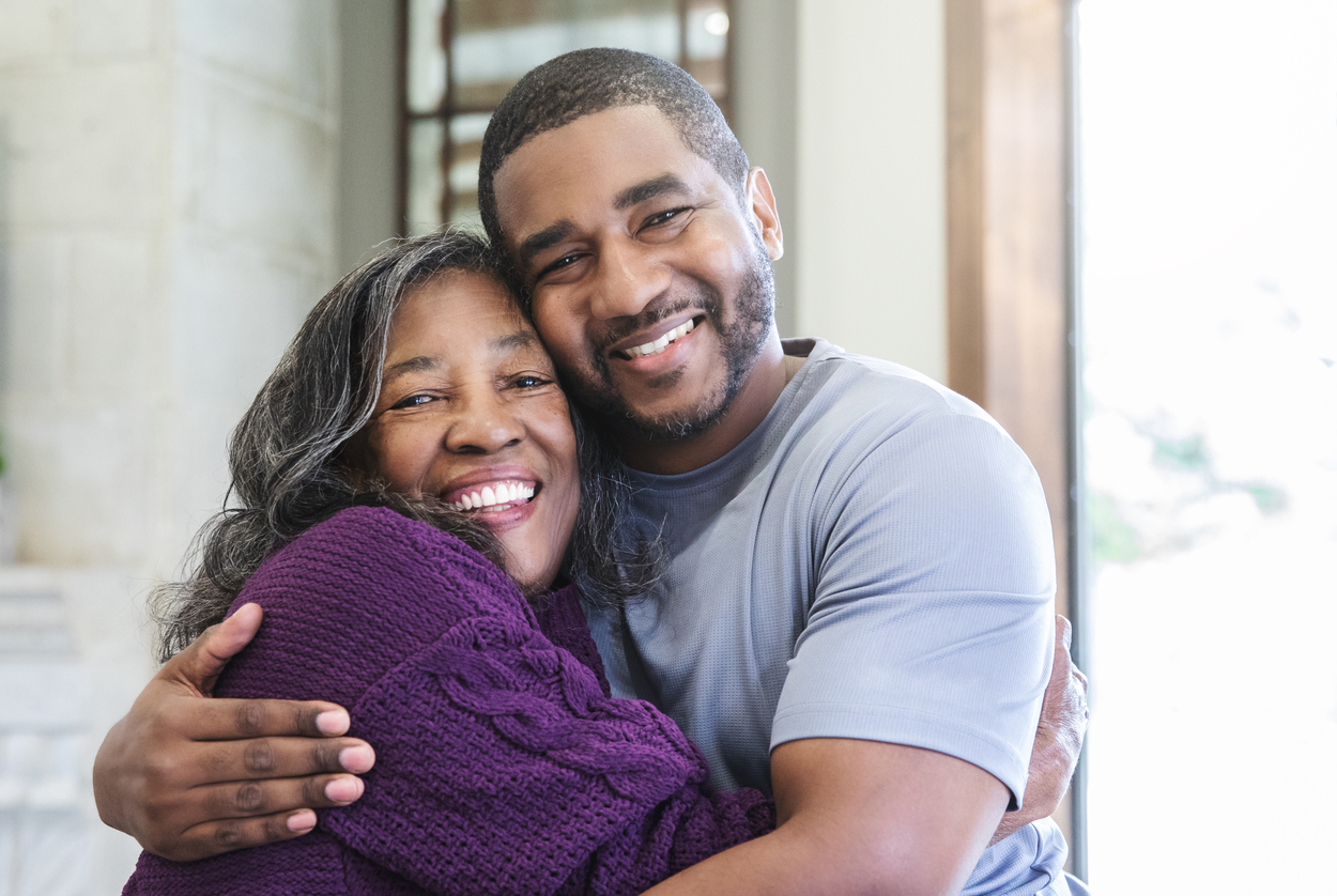 Adult son embracing senior mother