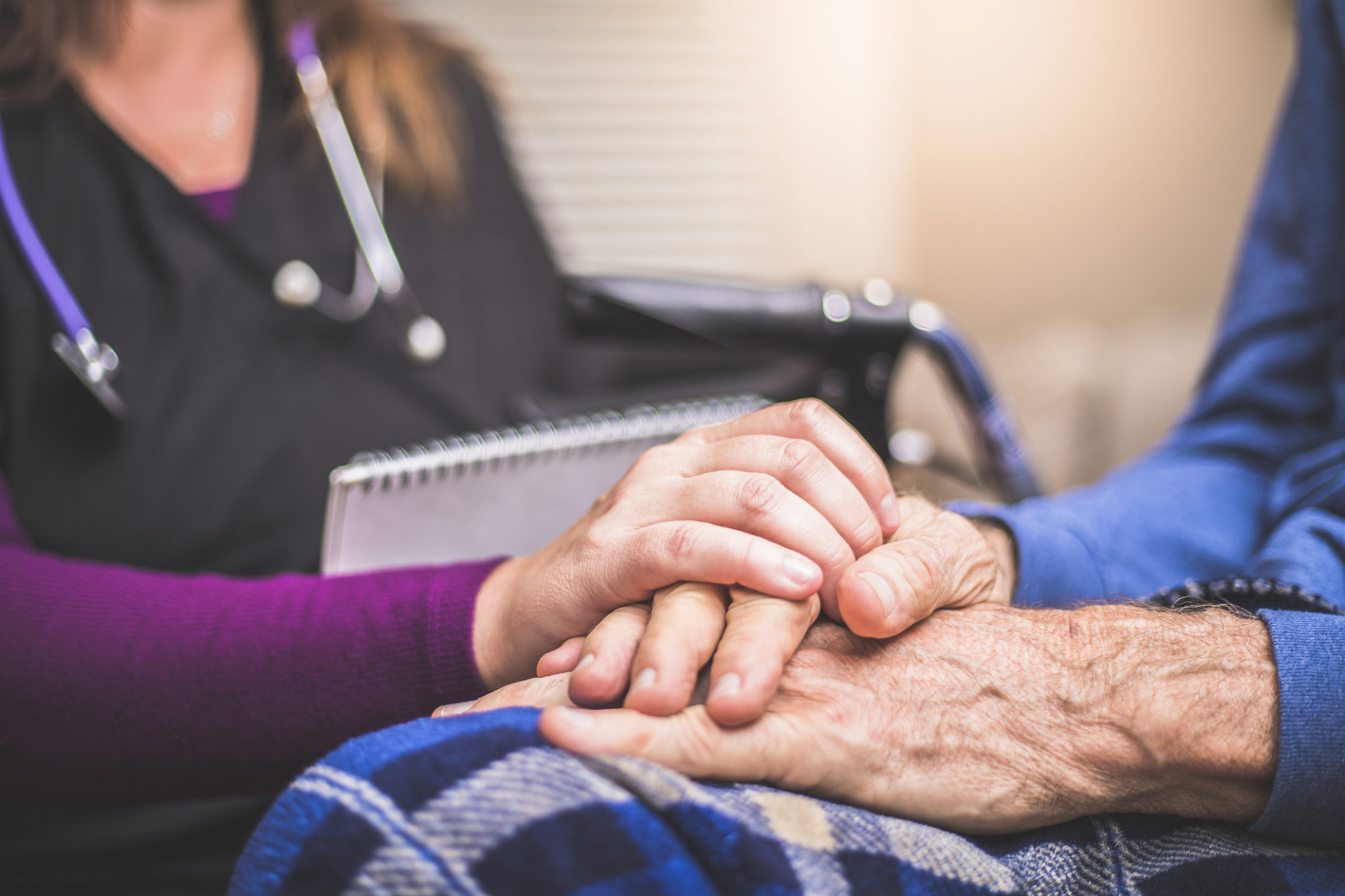 Hospice Nurse visiting an elderly male patient A stock photo of a Hospice Nurse visiting an Elderly male patient who is receiving hospice/palliative care.