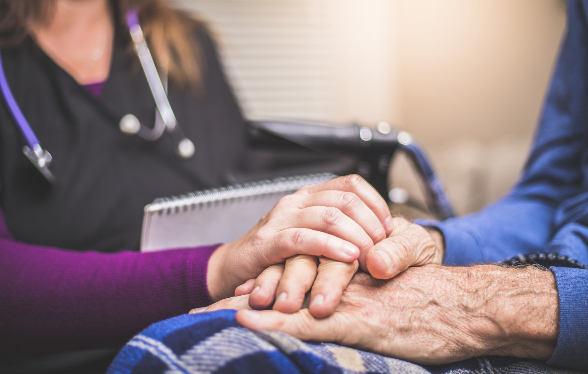 Hospice Nurse visiting an elderly male patient A stock photo of a Hospice Nurse visiting an Elderly male patient who is receiving hospice/palliative care.