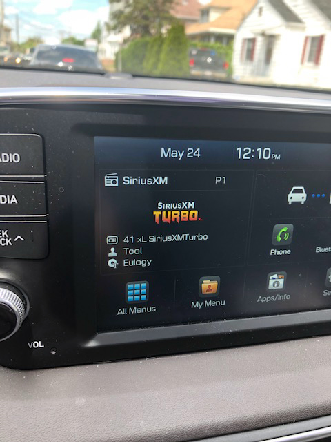 dashboard of radio screen shows song playing is Eulogy by Tool