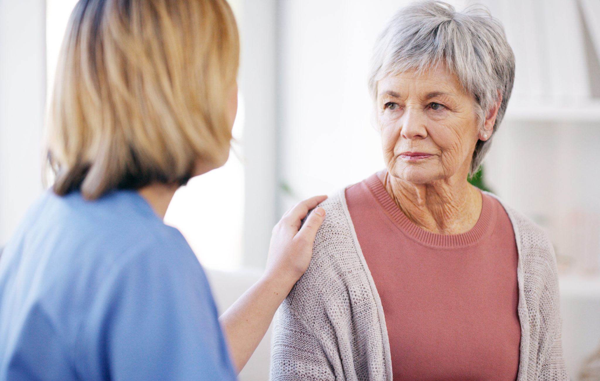 So...here's the prognosis Cropped shot of a young female caregiver consoling a senior patient in a nursing home