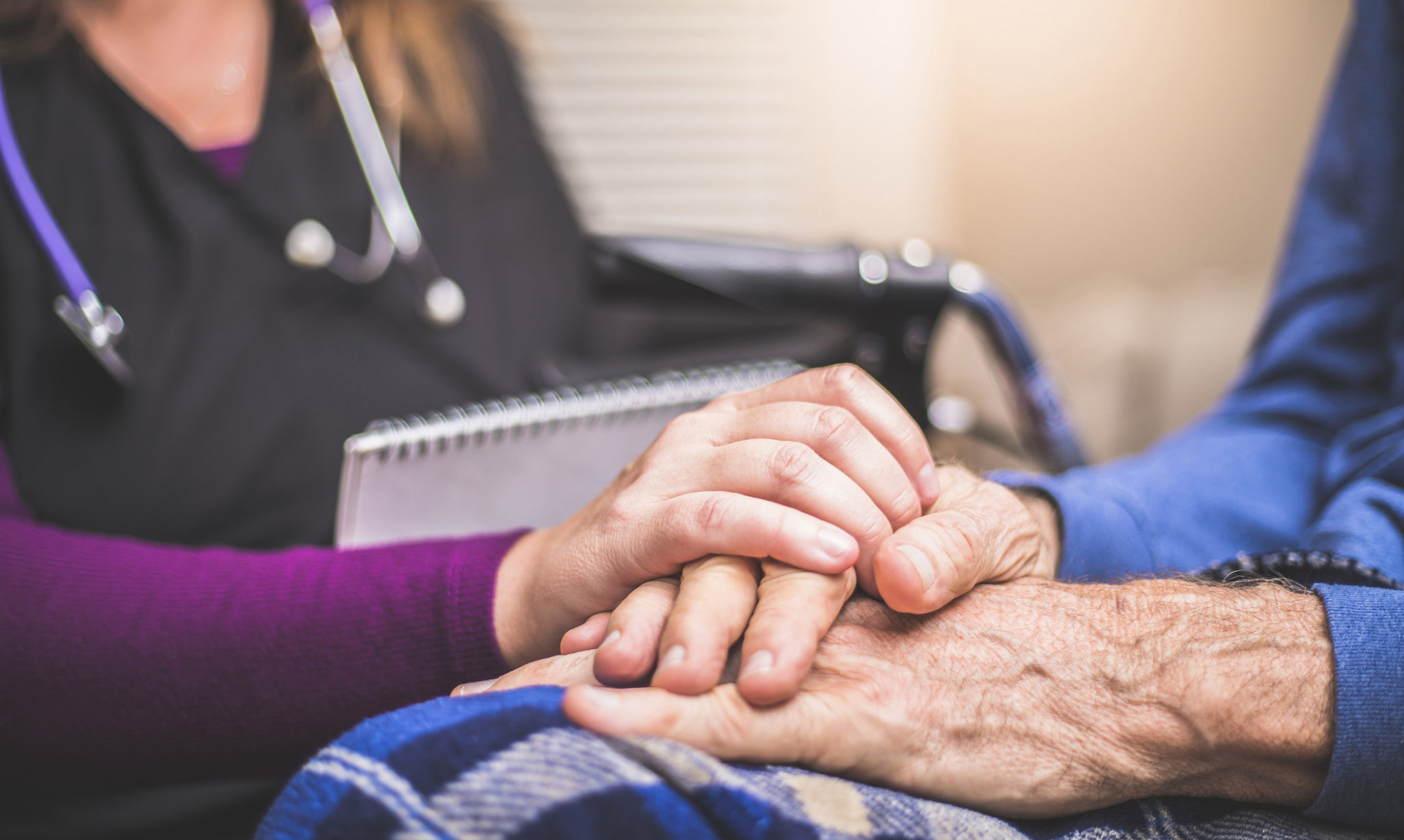 Hospice Nurse visiting an elderly male patient A stock photo of a Hospice Nurse visiting an Elderly male patient who is receiving hospice/palliative care.