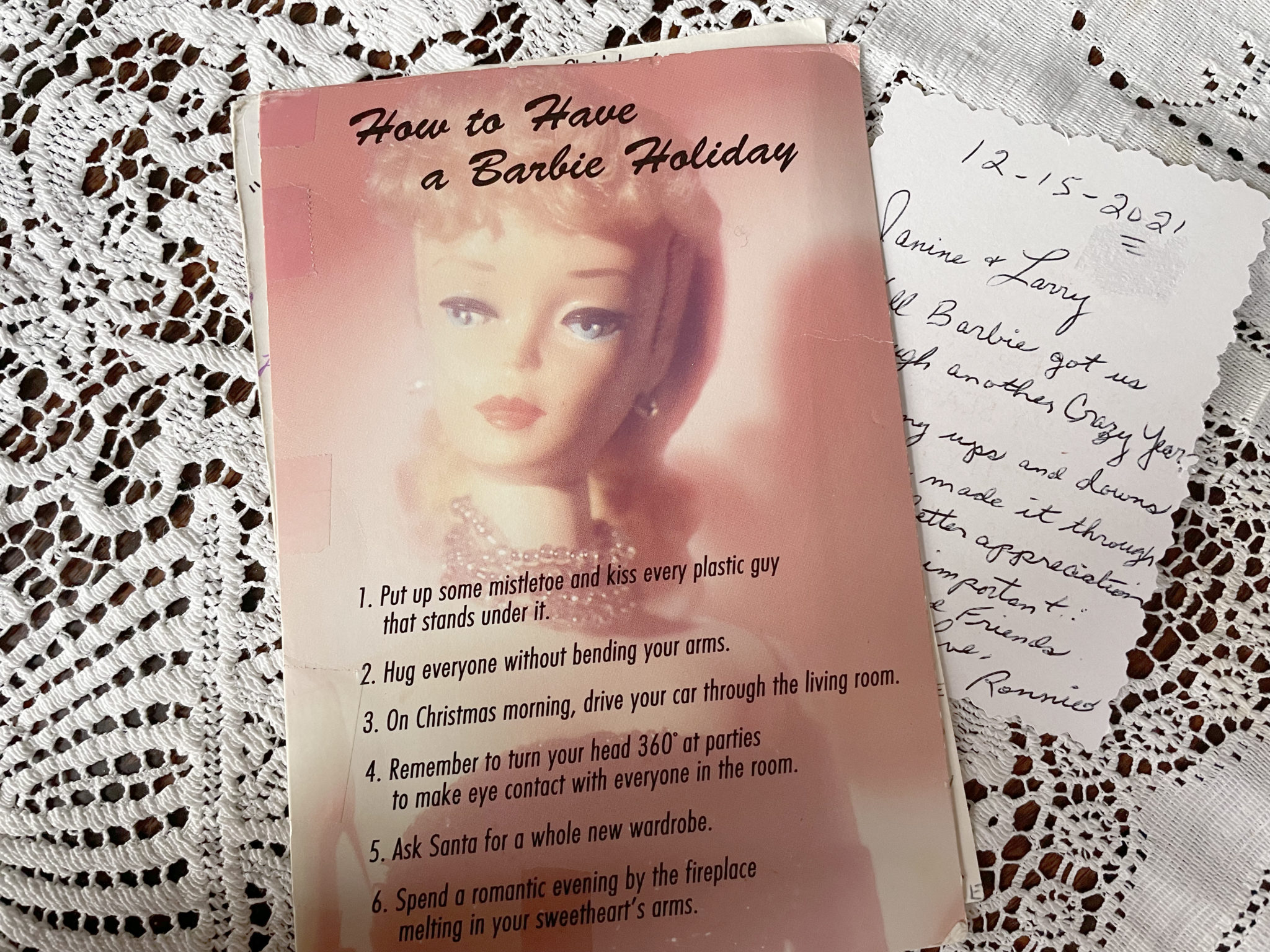 Card with photo of vintage Barbie doll on cover and handwritten note over lace tablecloth