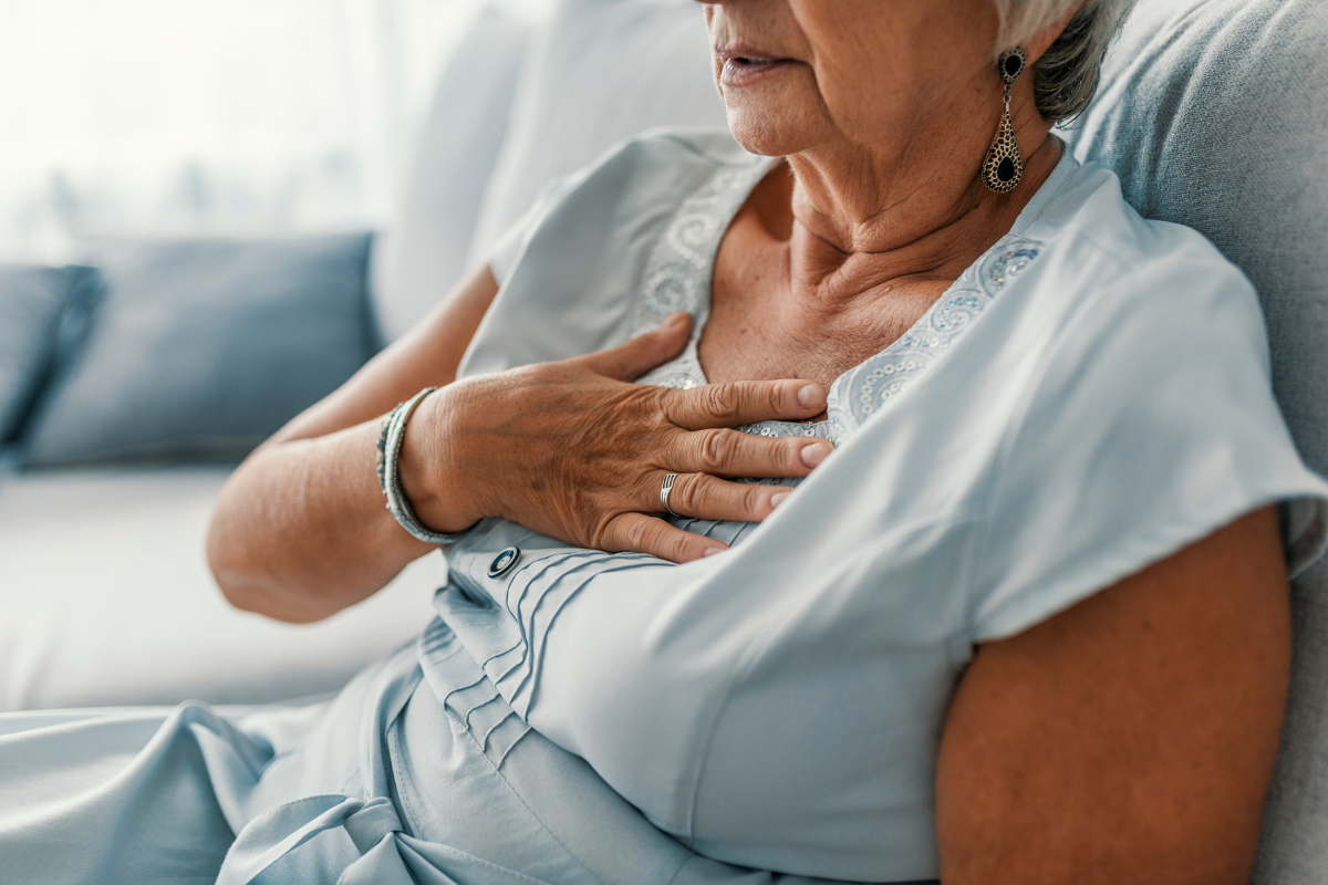 older woman holding chest