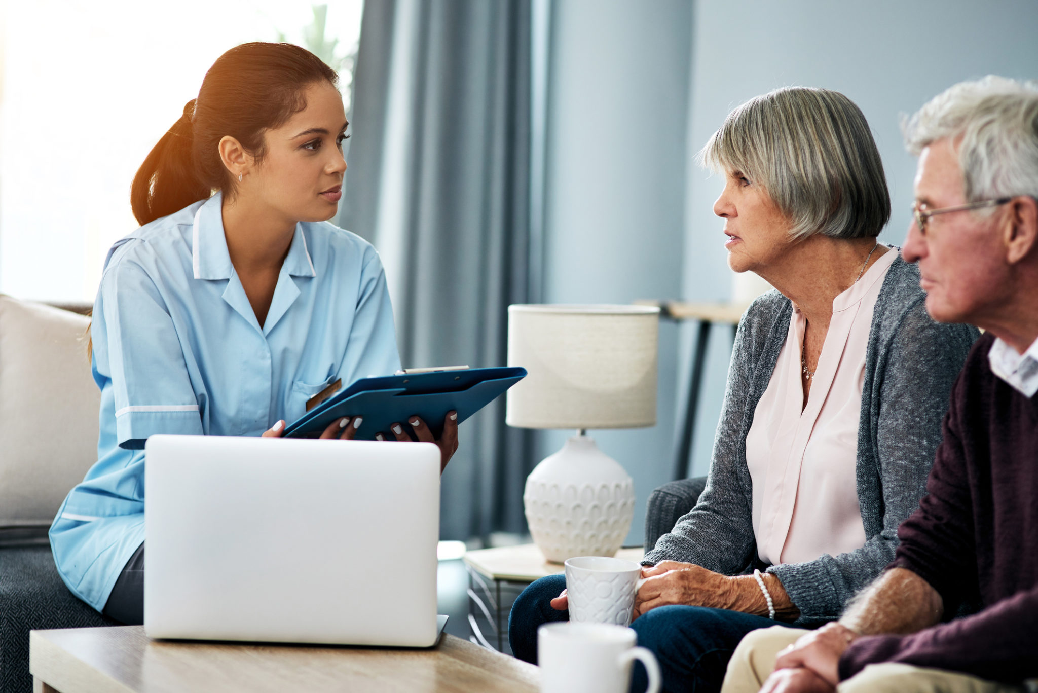 Shot of a young nurse having a discussion with a senior couple