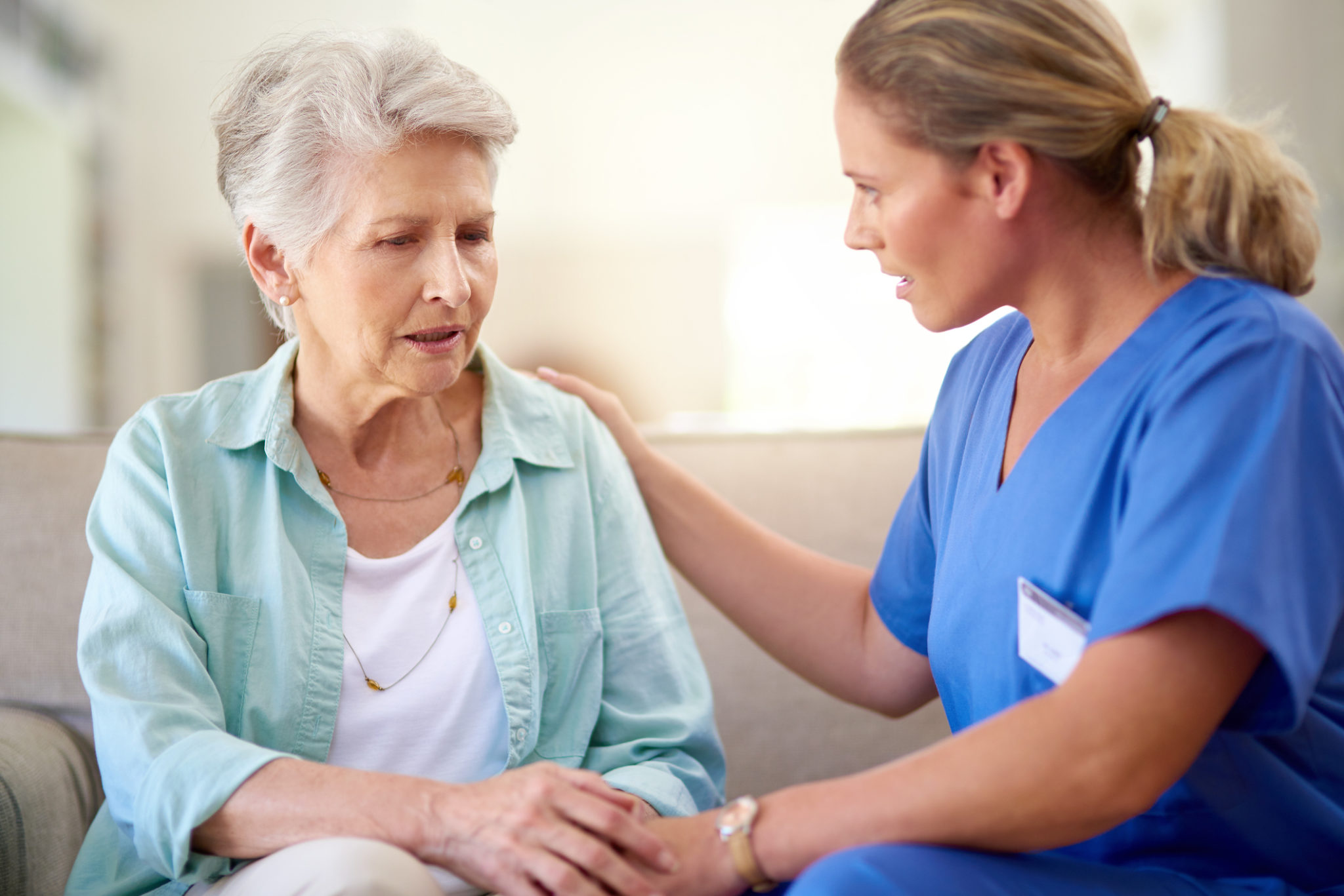 Sometimes my burdens and sorrows become too overwhelming to bear... Shot of a caregiver consoling a senior patient in a nursing home