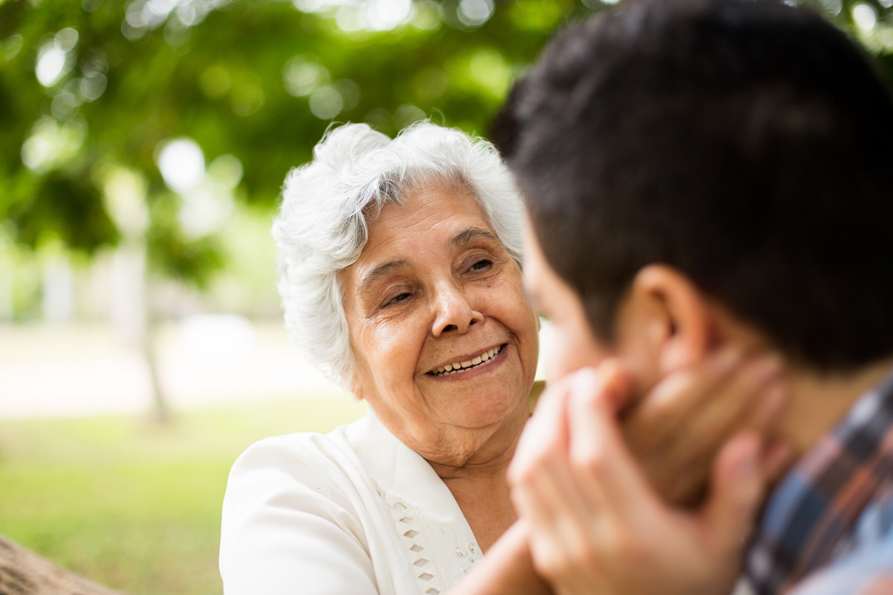 Grandmother touching cheek of grandson