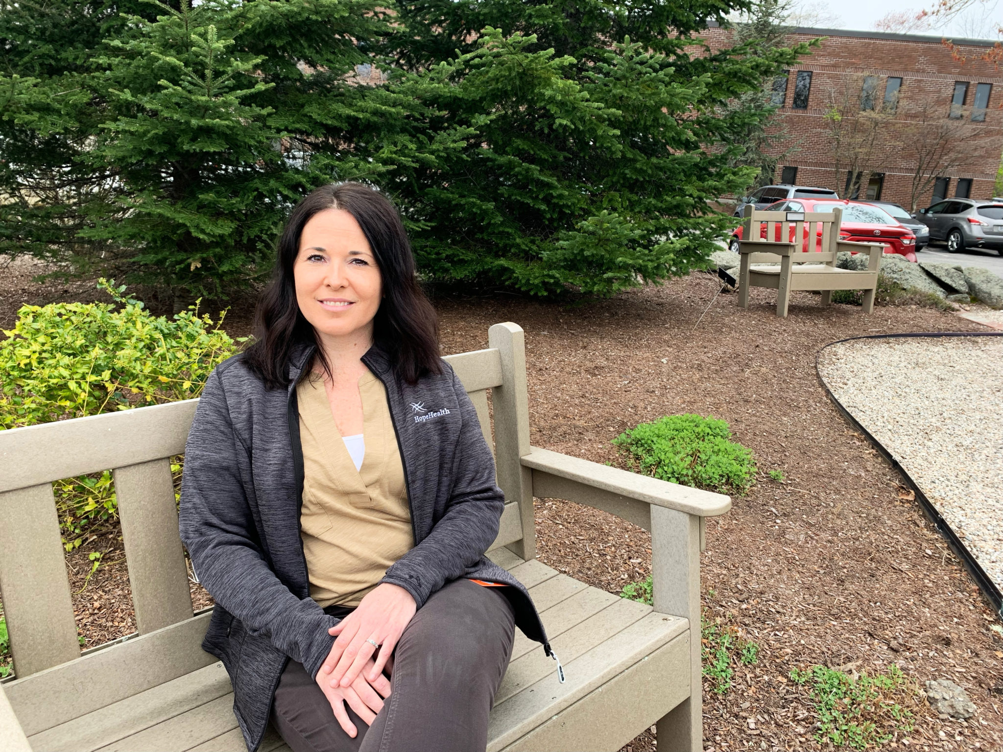 Home care cardiac nurse sits on a park bench
