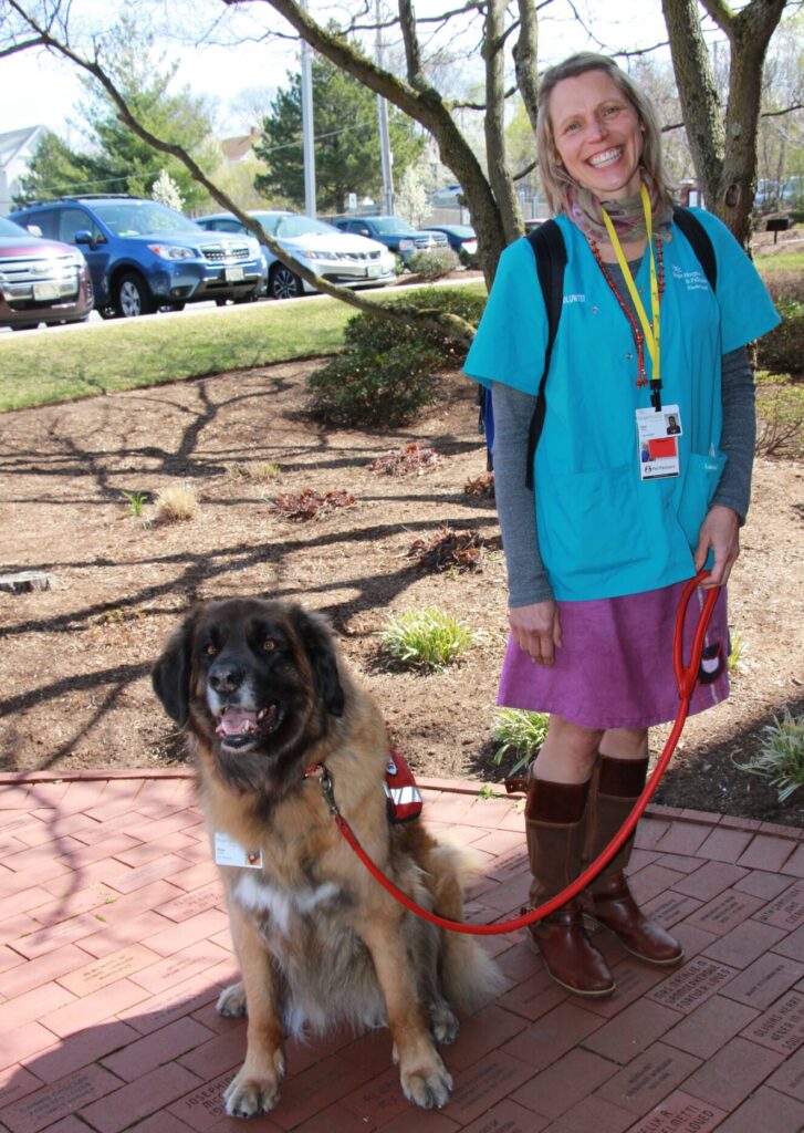 Woman standing wiith her large Leonberger dog