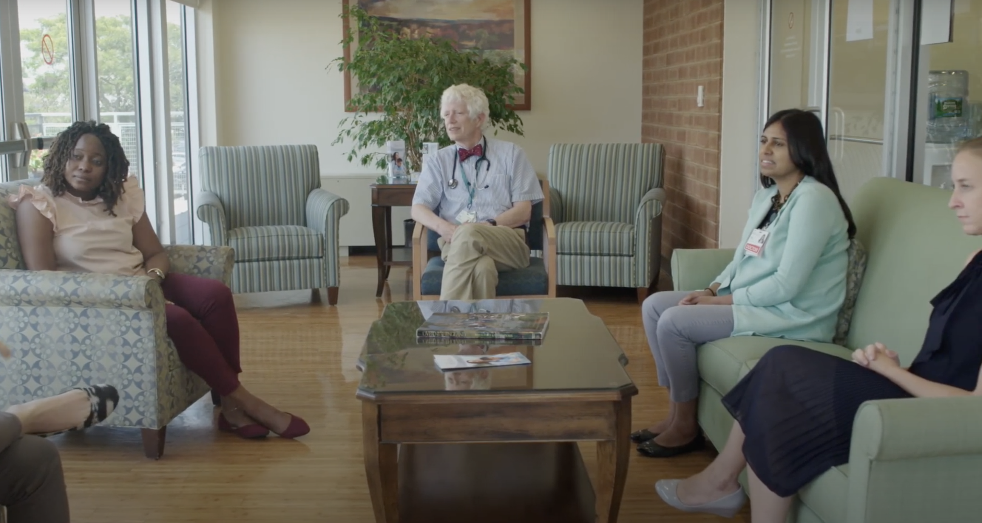 Doctors sitting around a coffee table discussing goals of care