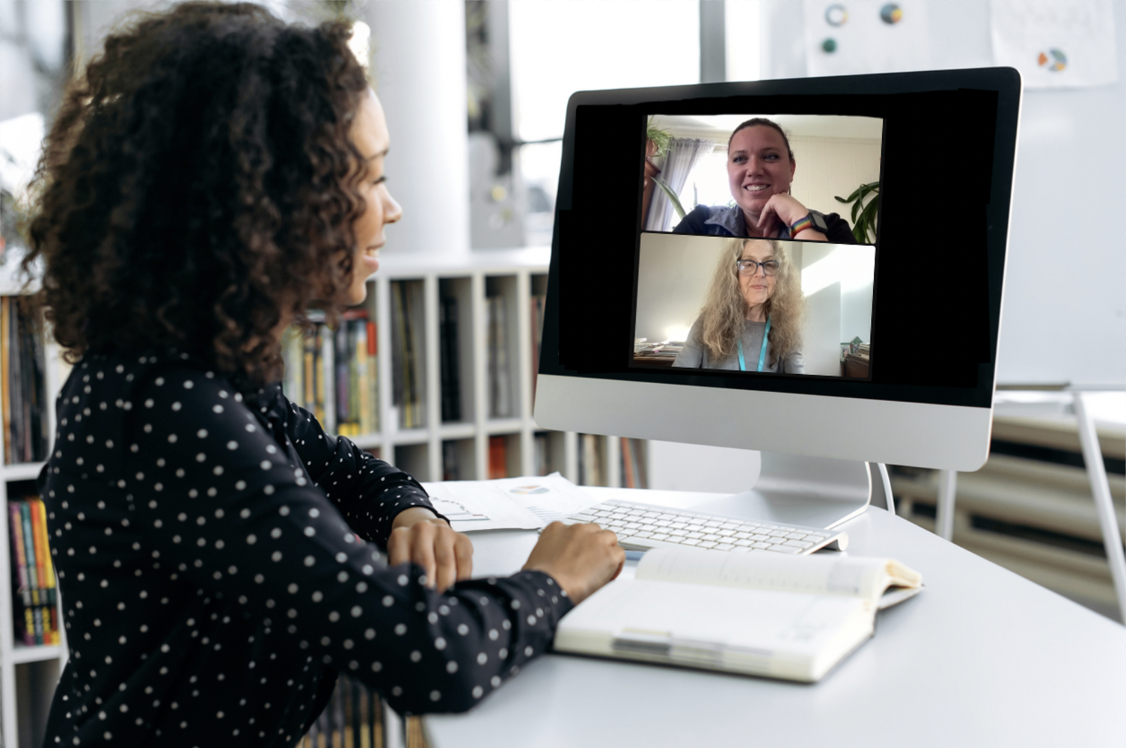 Woman sitting at her desk with a computer screen in front of her. She's partaking in a virtual grief support group